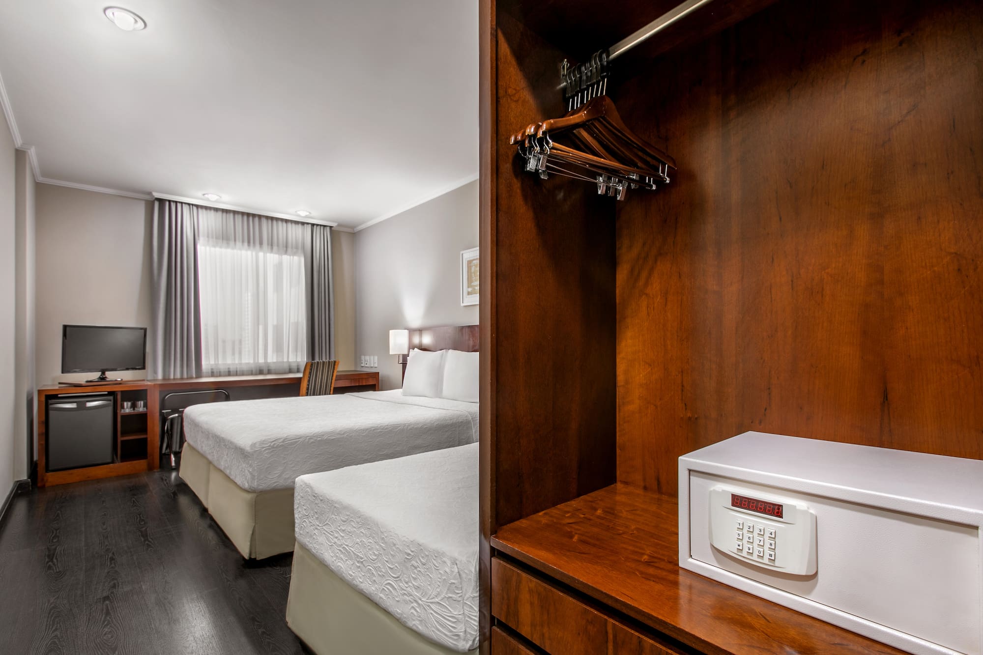 a room with two beds and a small white box