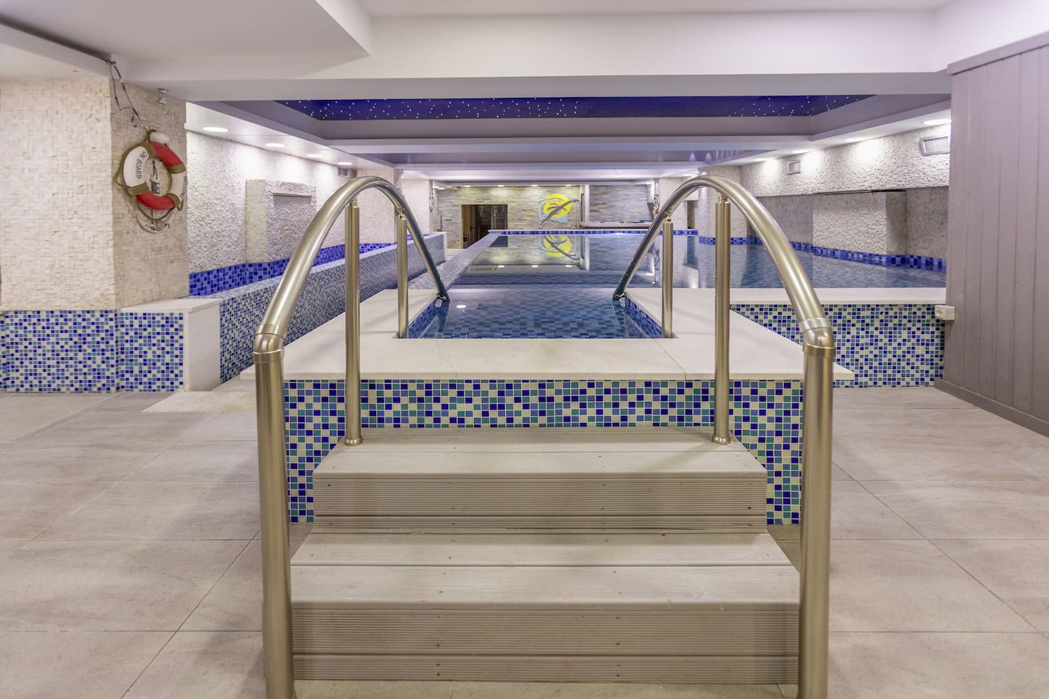 a swimming pool with stairs and railings