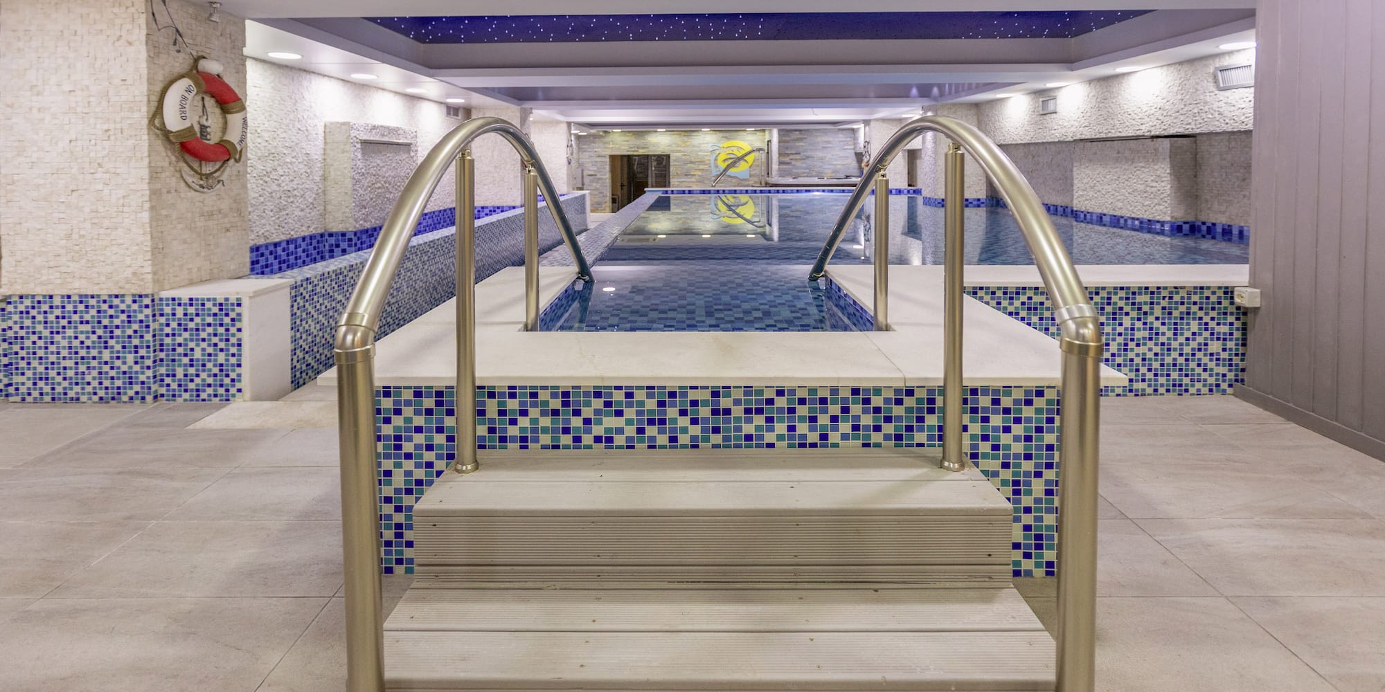 a swimming pool with stairs and railings