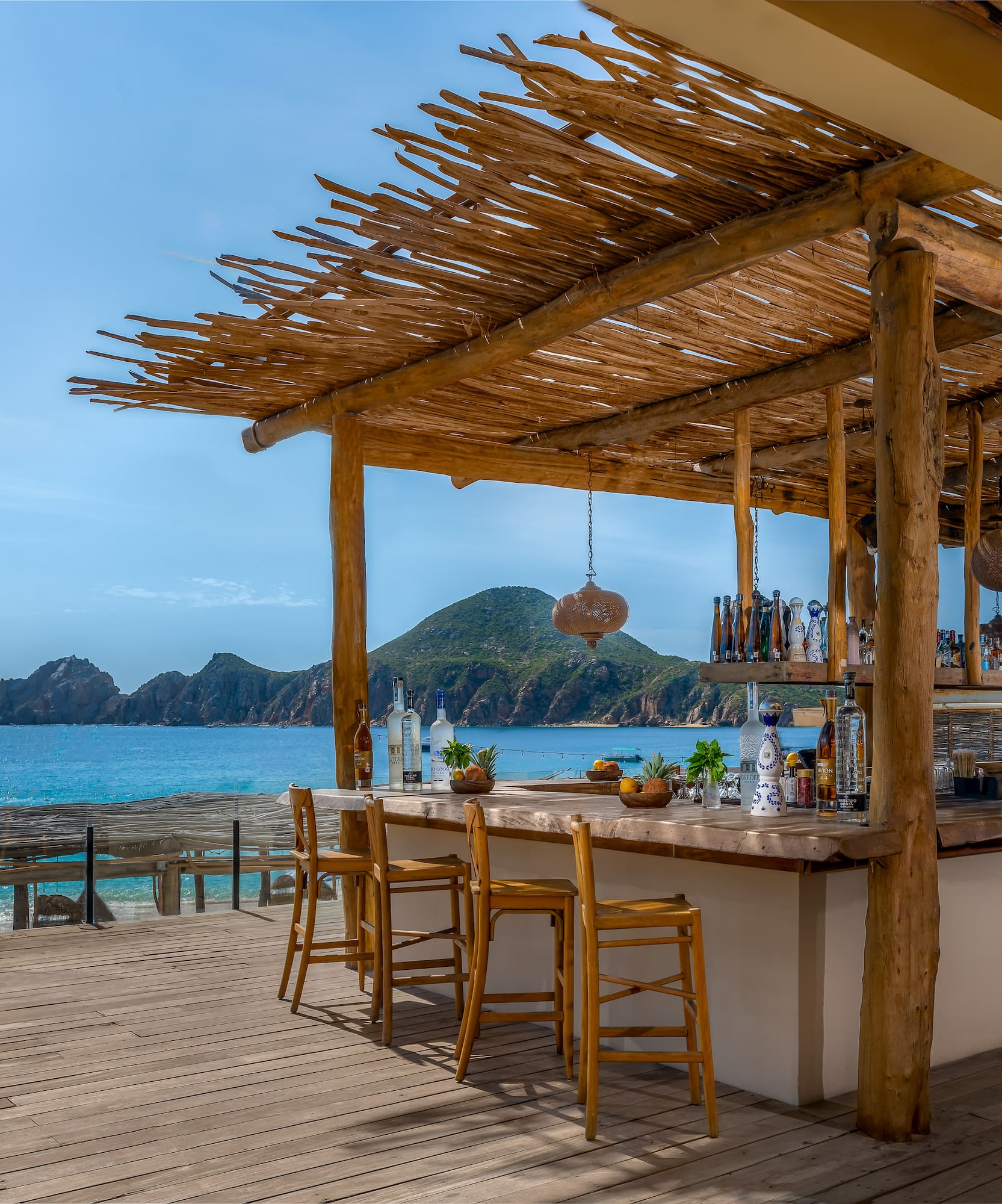a bar with chairs and a table on a beach