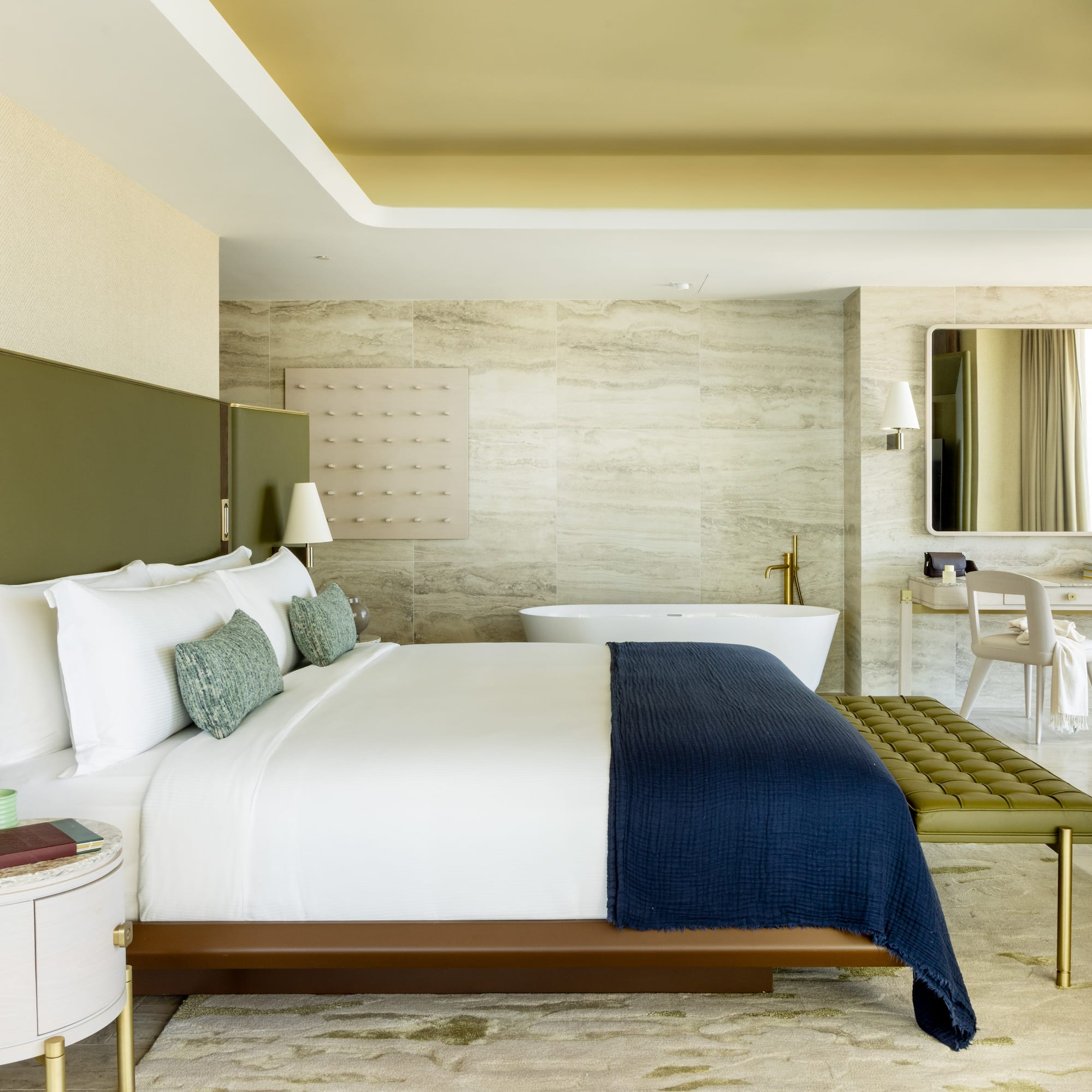 a bedroom with a bathtub and a bed