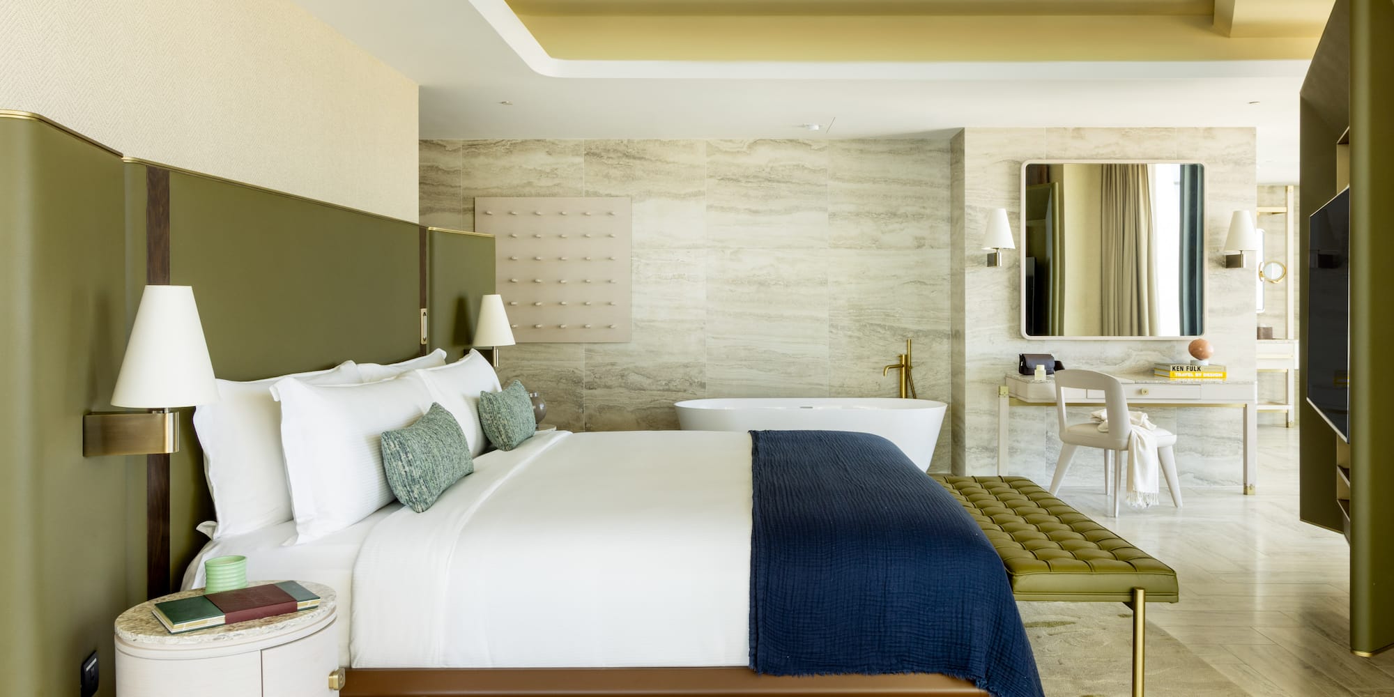 a bedroom with a bathtub and a bed