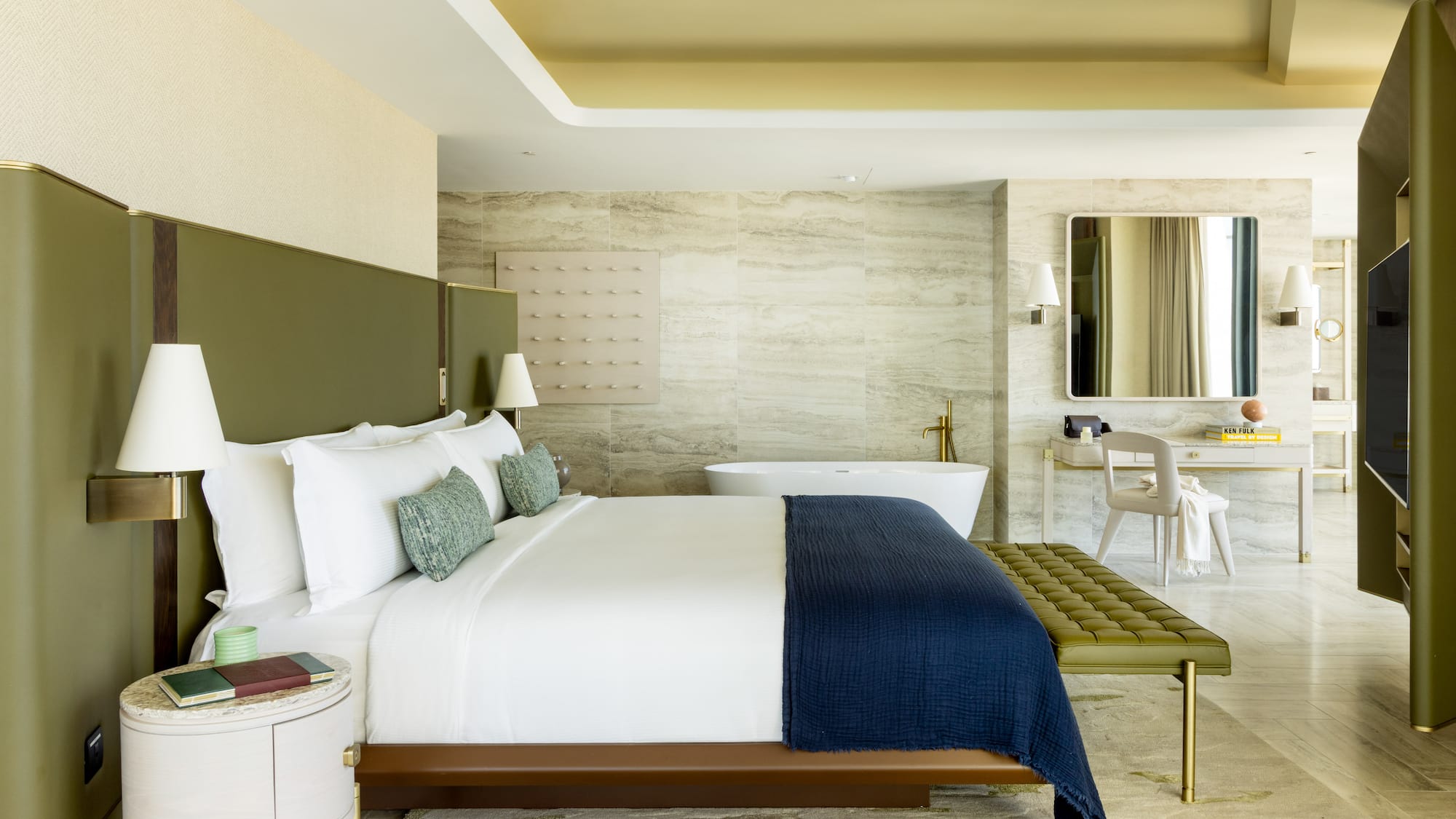 a bedroom with a bathtub and a bed