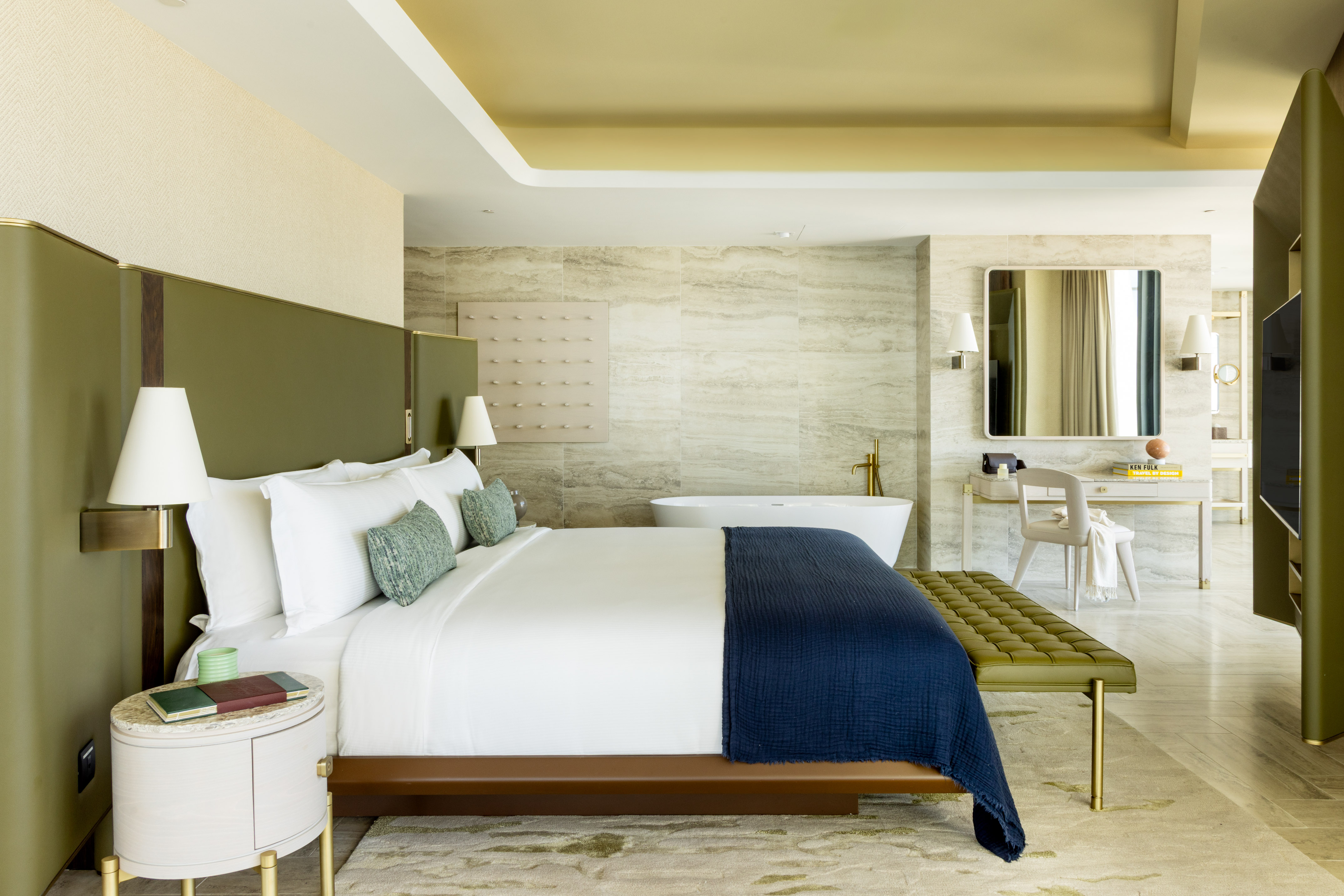 a bedroom with a bathtub and a bed