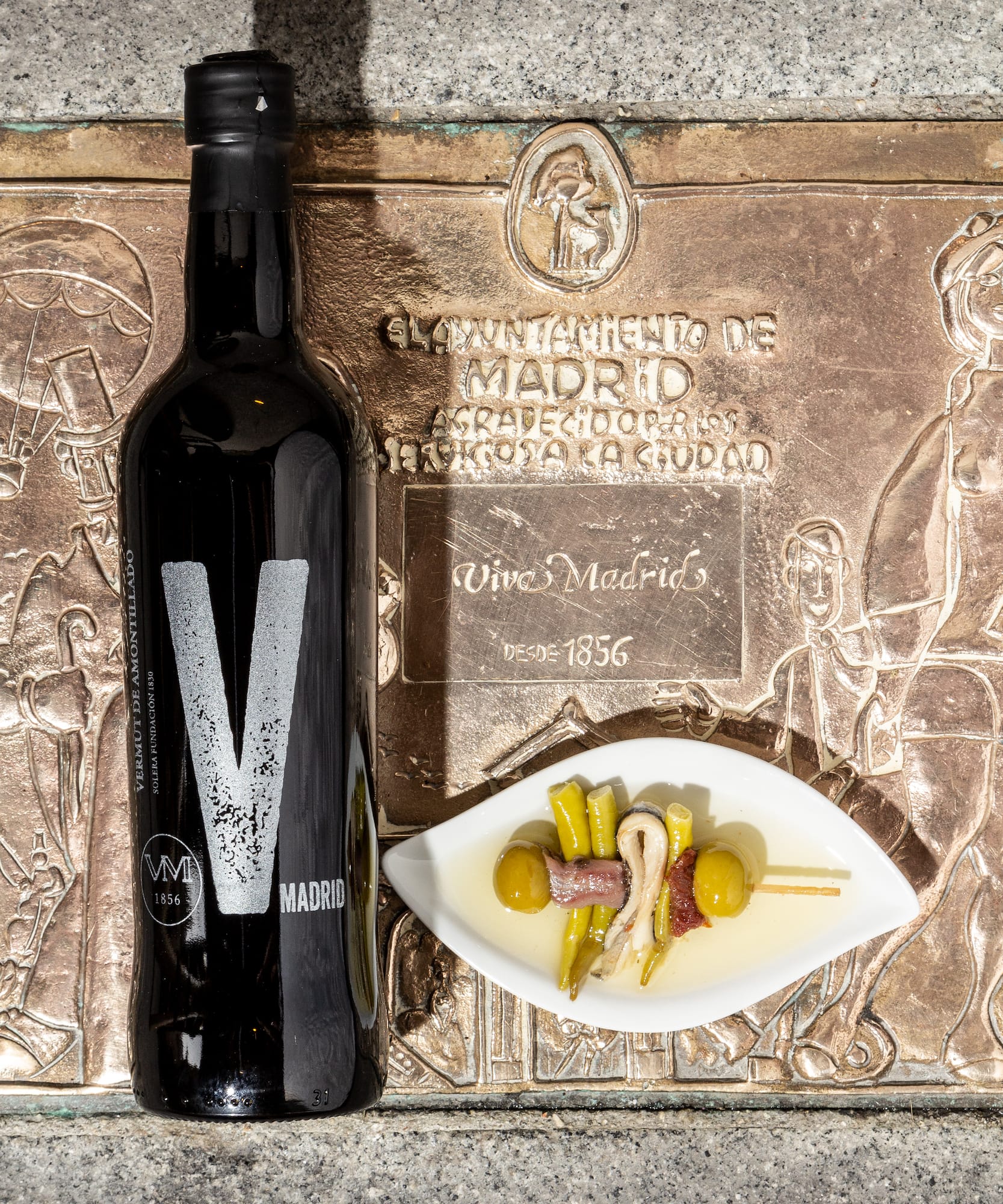a wine bottle beside a plate of food
