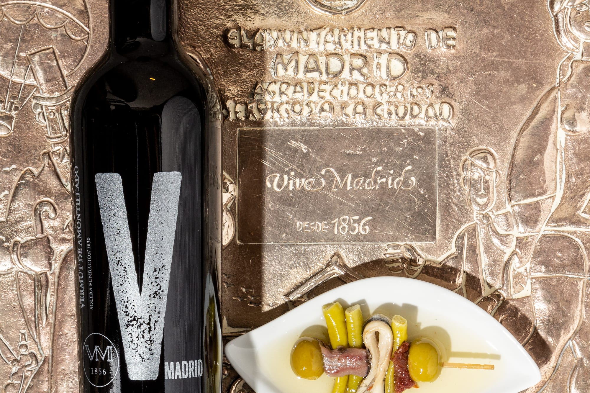 a wine bottle beside a plate of food