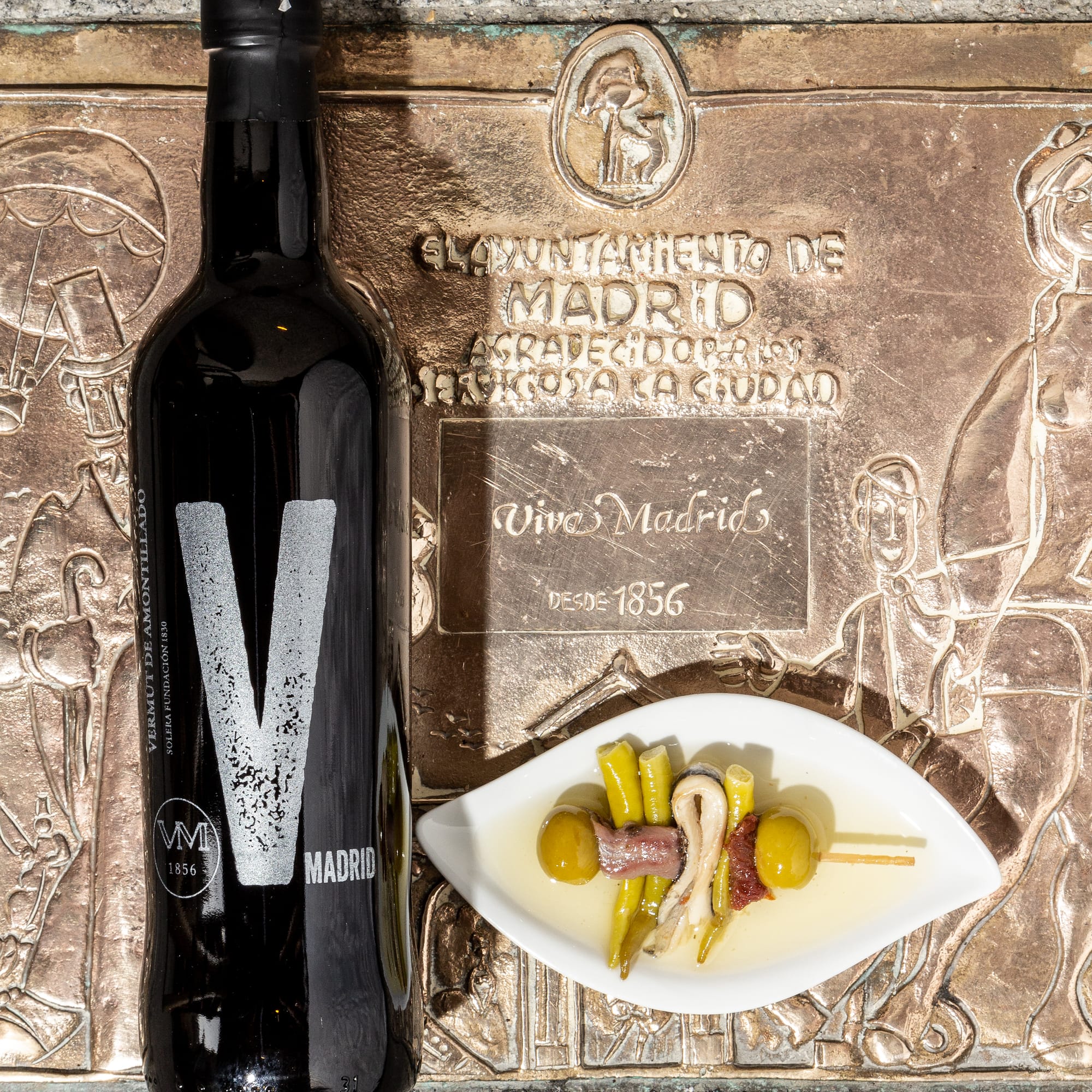 a bottle of wine beside a plate of food