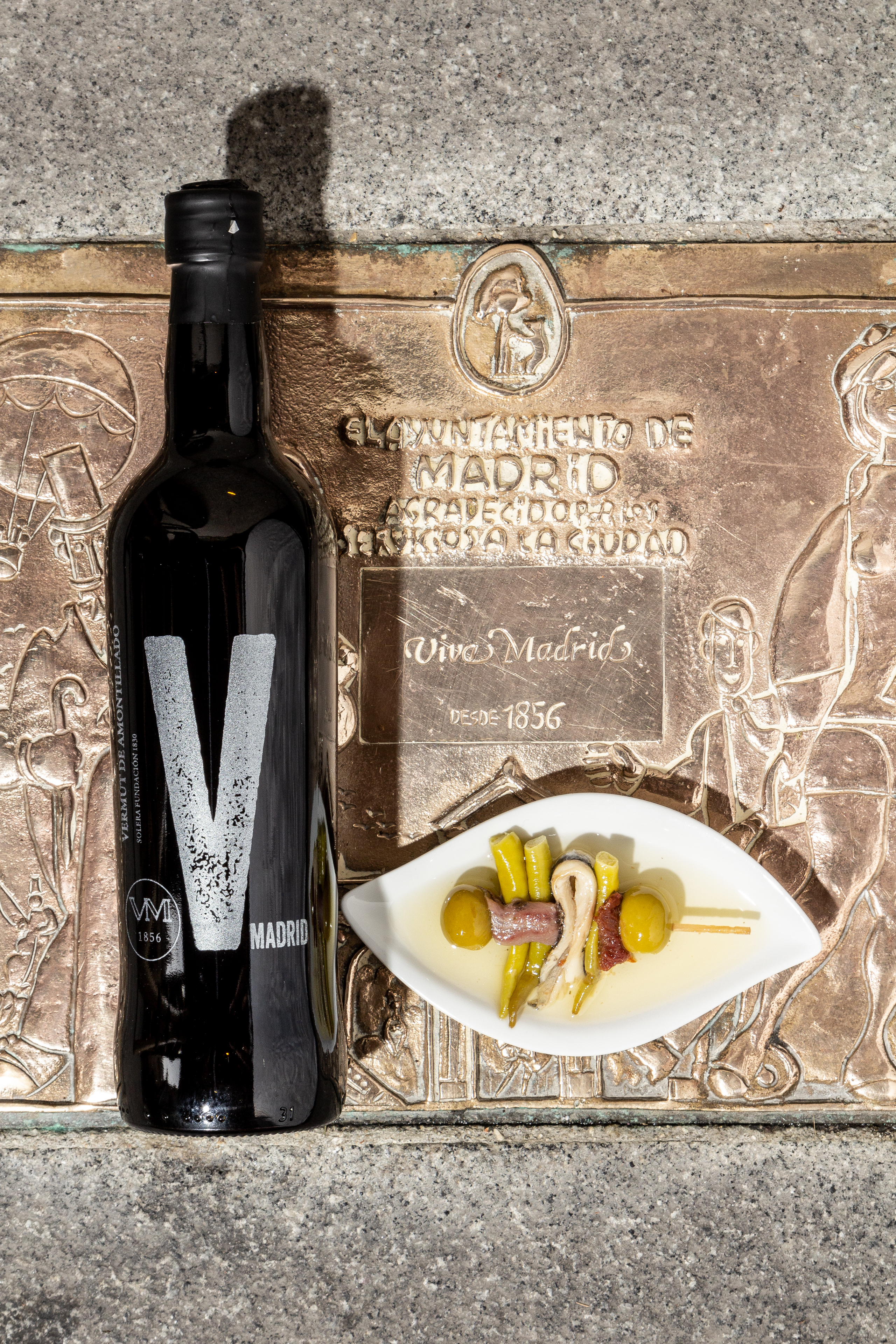 a bottle of wine next to a plate of food