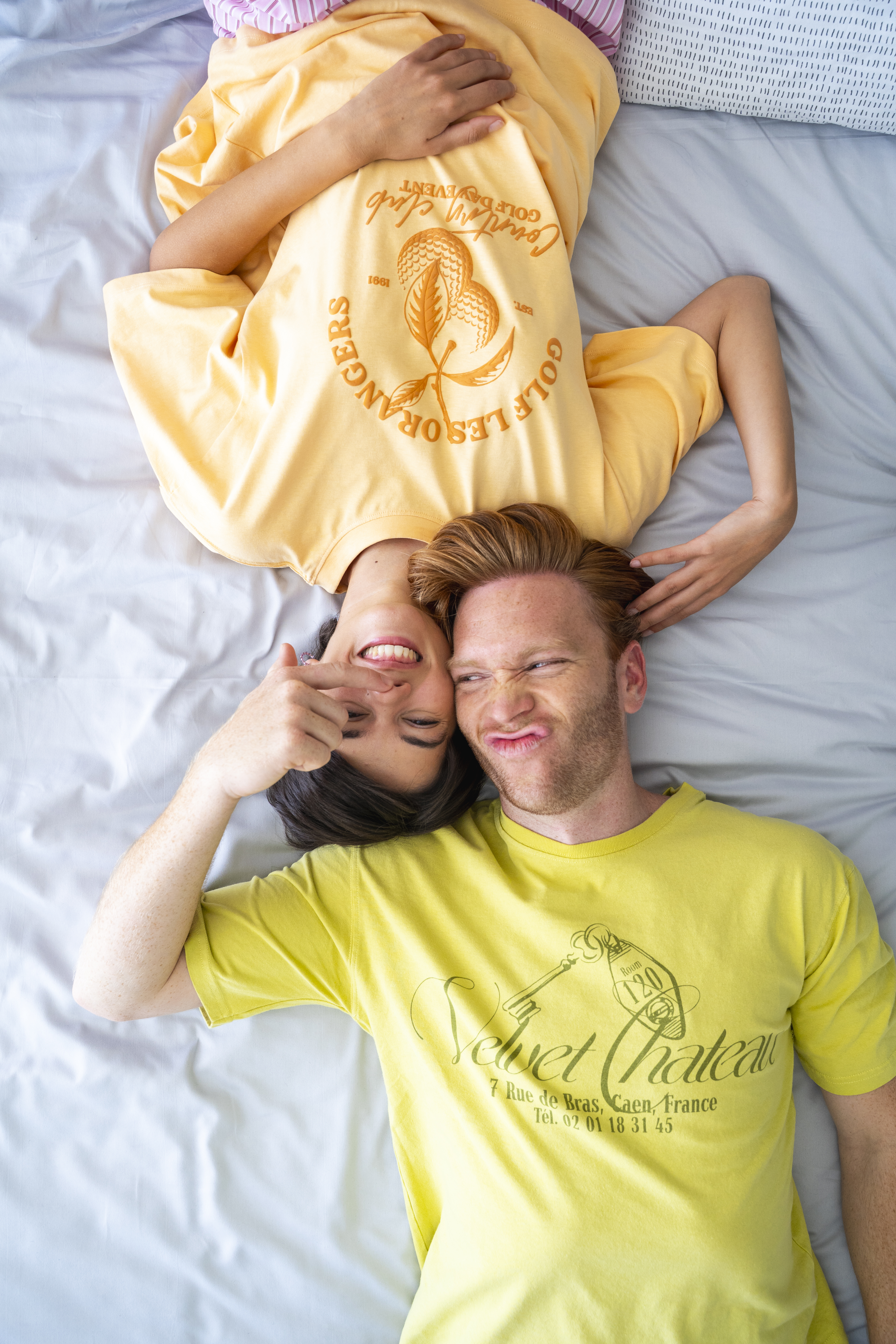 a man and woman lying on a bed