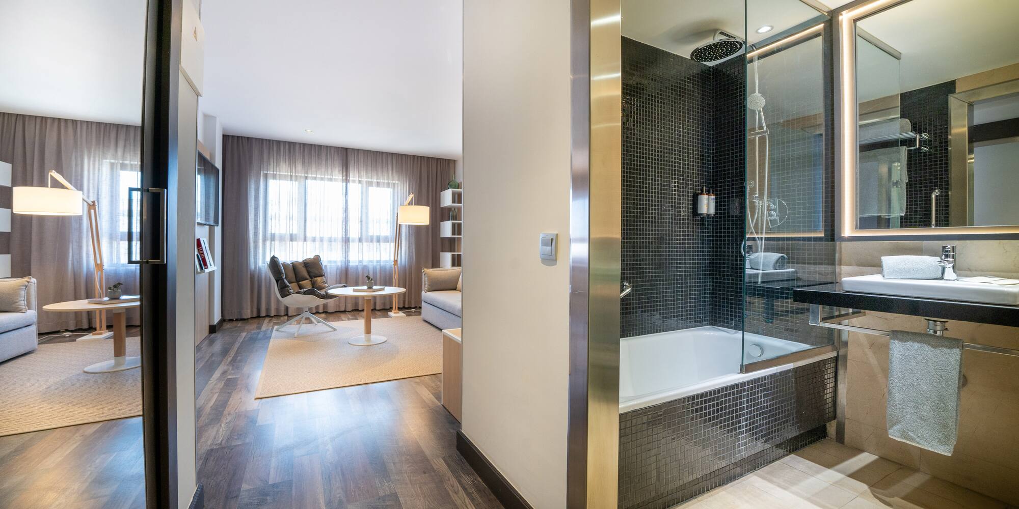a bathroom with a glass shower and a tub