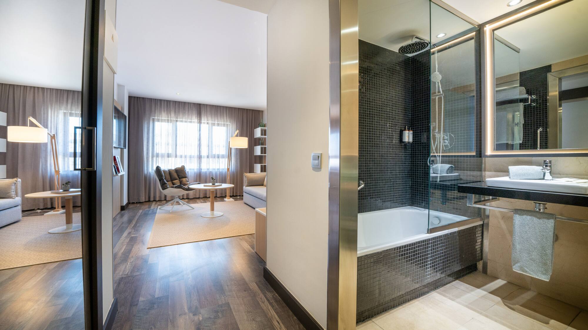 a bathroom with a glass shower and a tub
