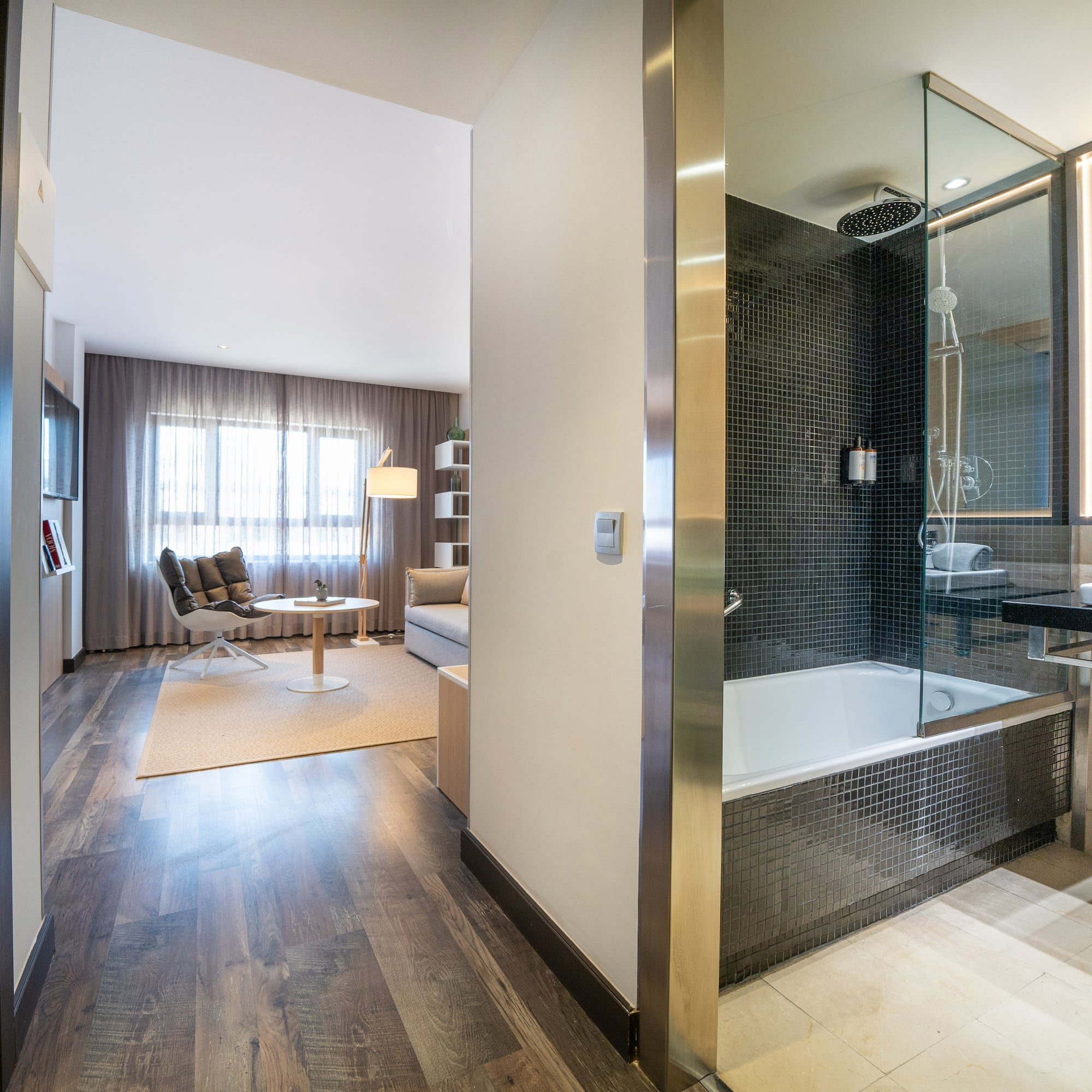 a bathroom with a glass shower and a tub