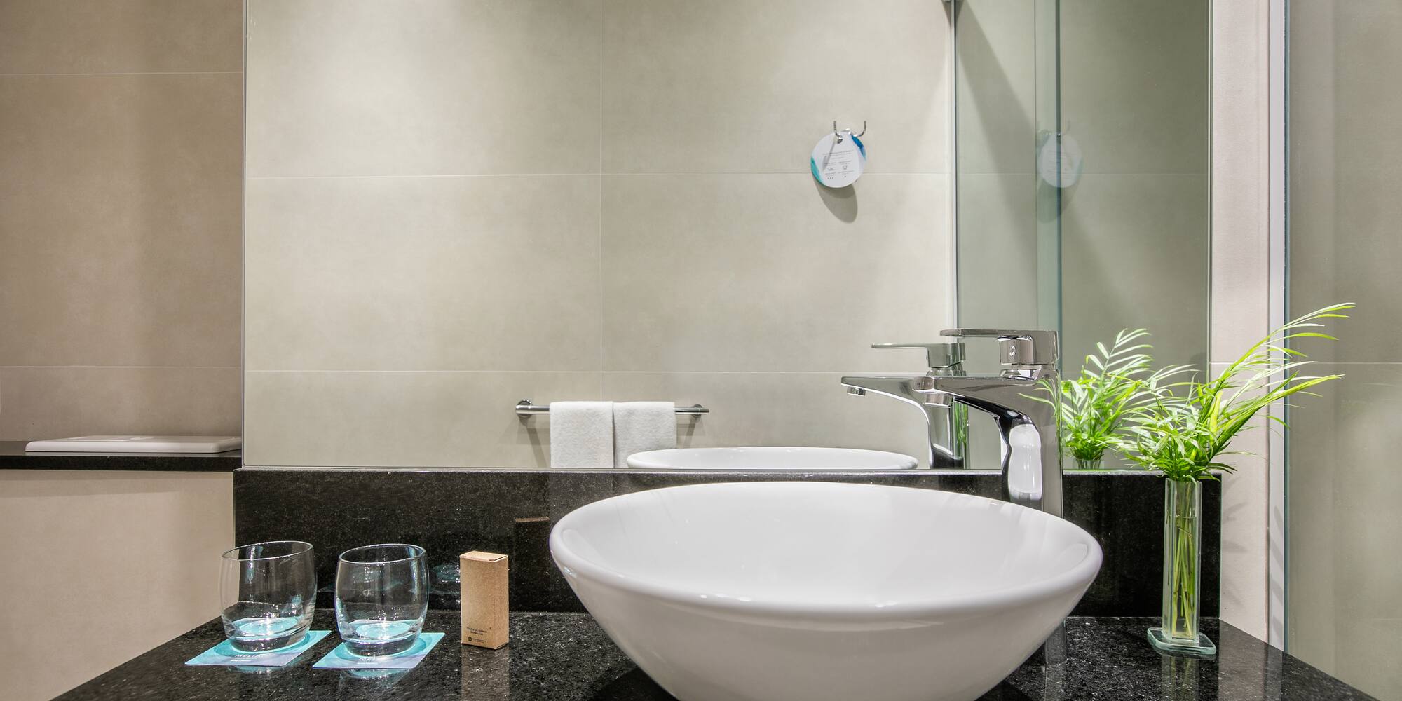 a sink and glasses in a bathroom