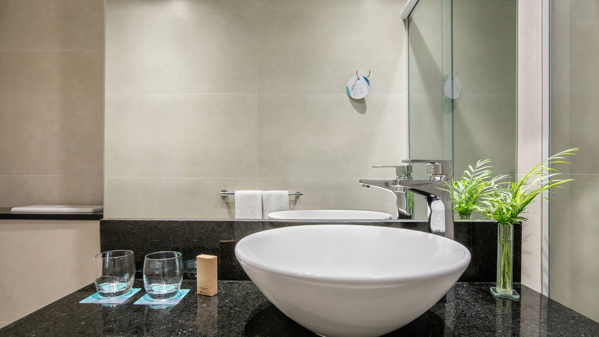 a sink and glasses in a bathroom