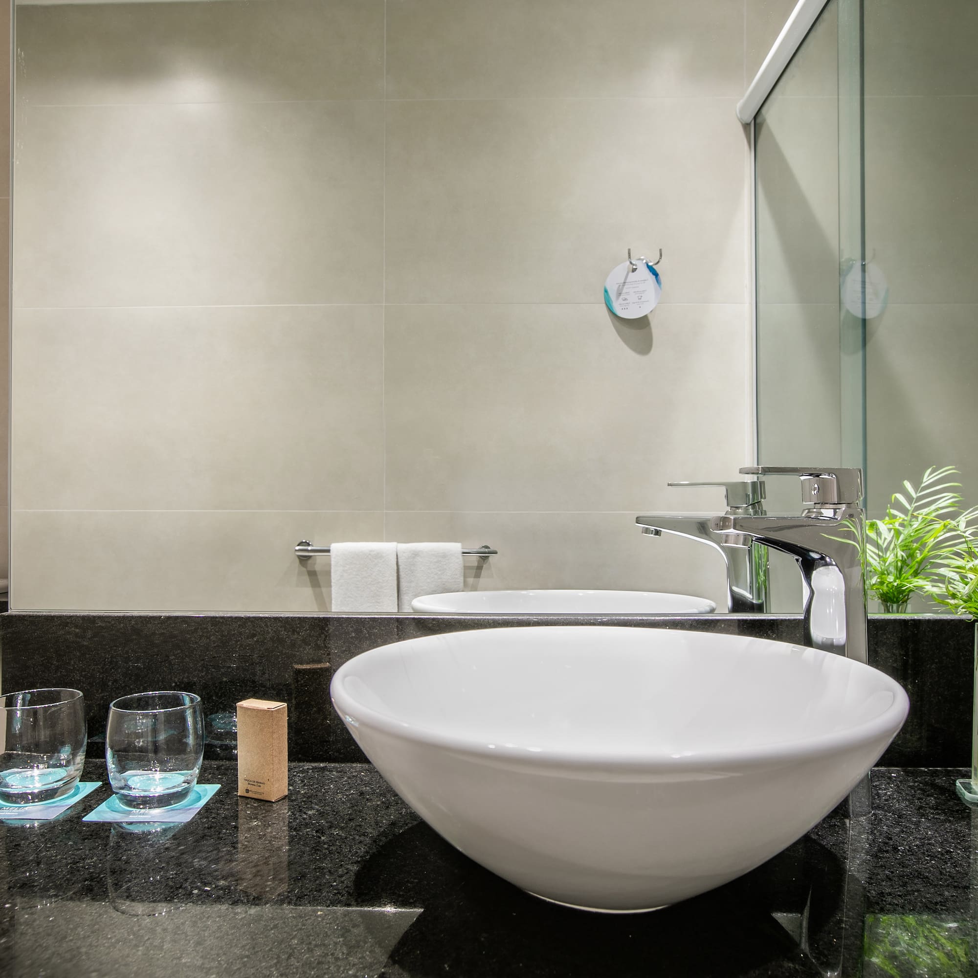 a sink and glasses in a bathroom