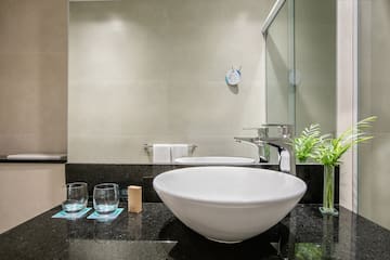 a sink and glasses in a bathroom