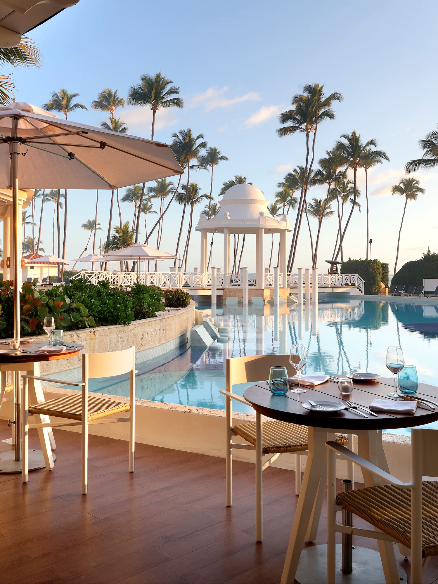a pool with tables and chairs