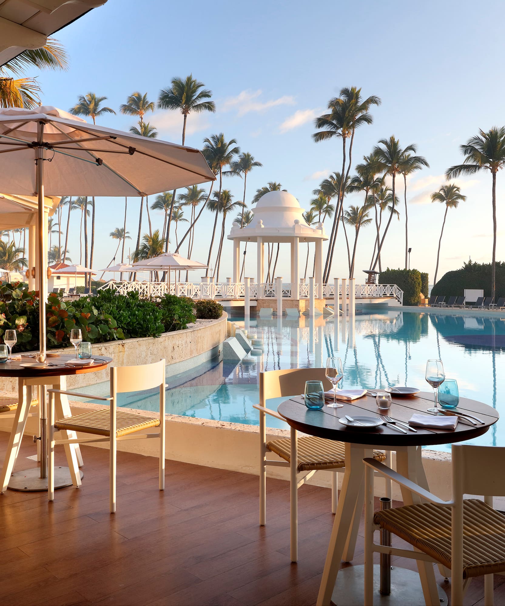 a pool with tables and chairs