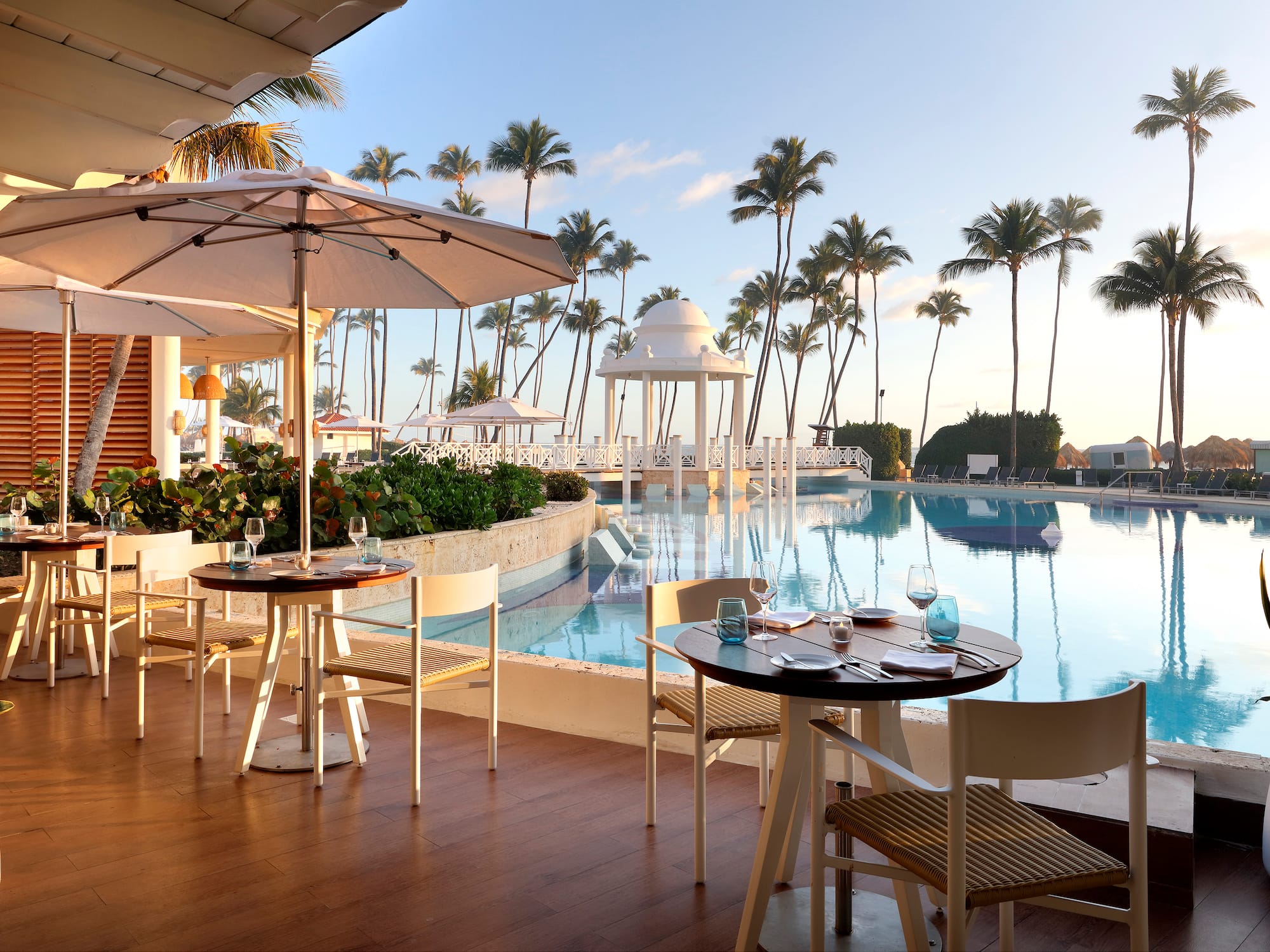 a pool with tables and chairs