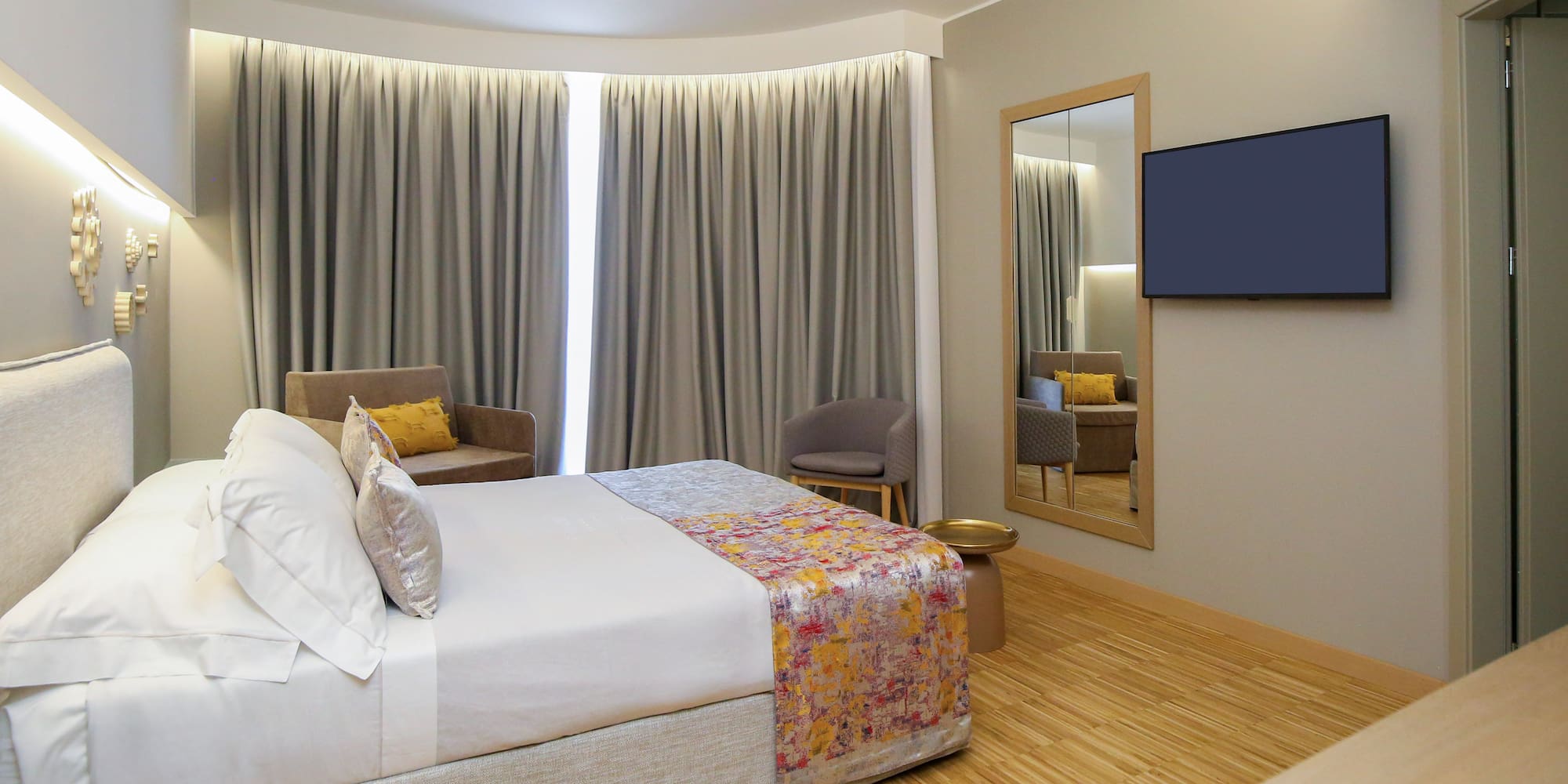 a room with a bed and a mirror