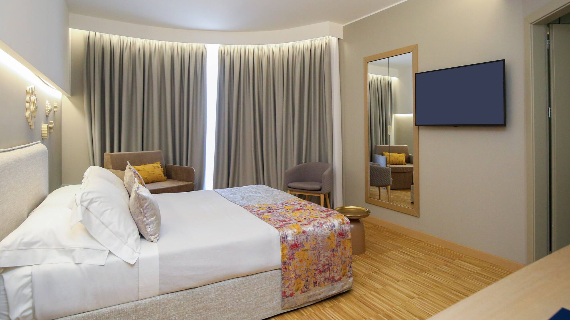 a room with a bed and a mirror