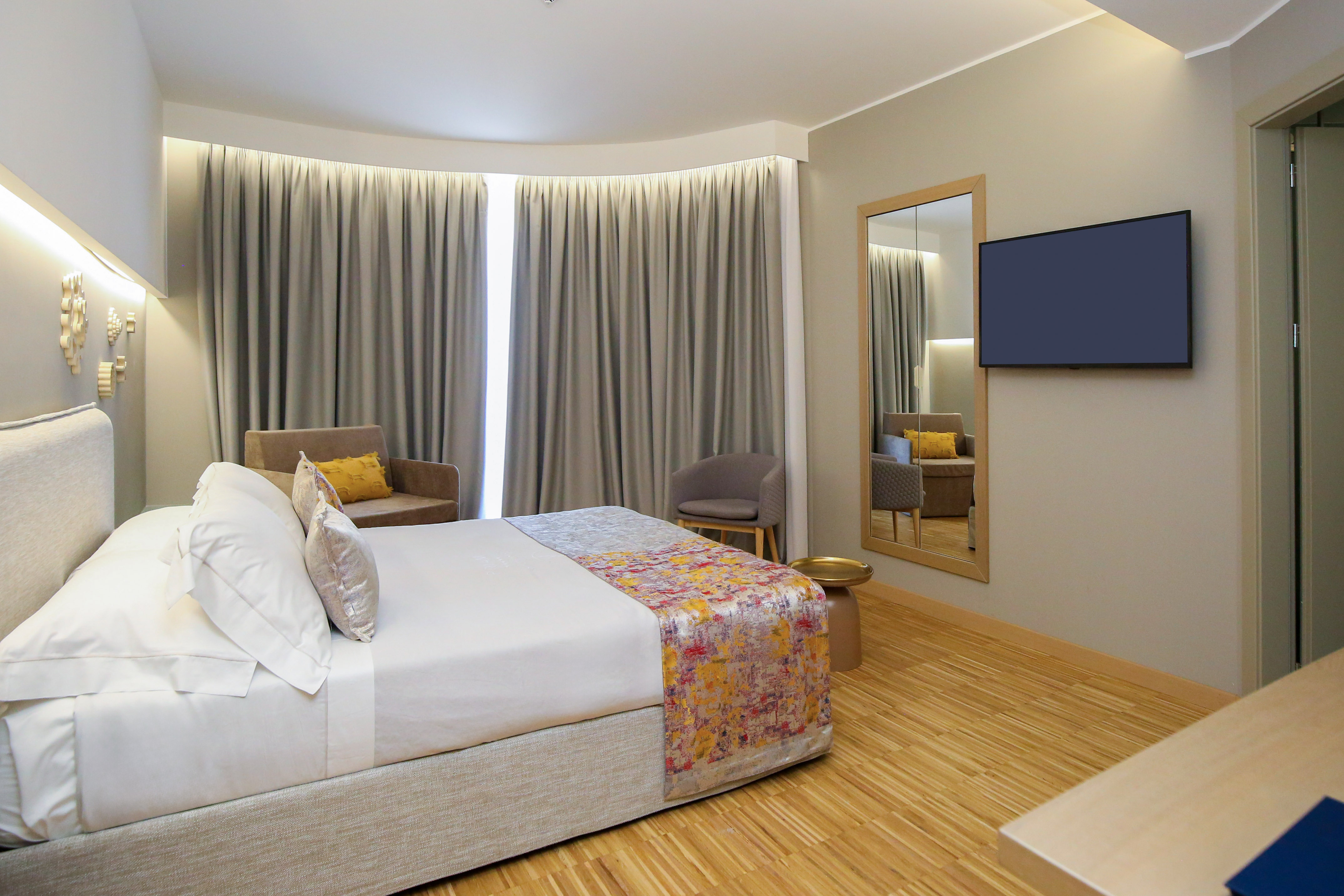 a room with a bed and a mirror