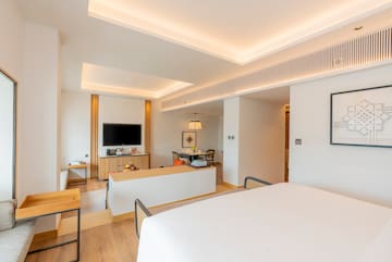 a room with a bed and a tv