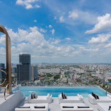 a pool with a view of a city and a blue sky