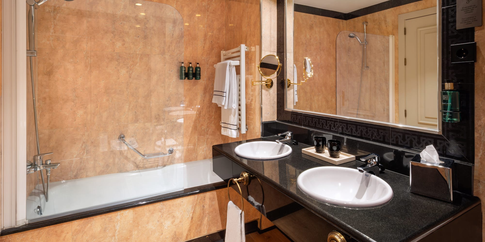 a bathroom with a large shower and two sinks