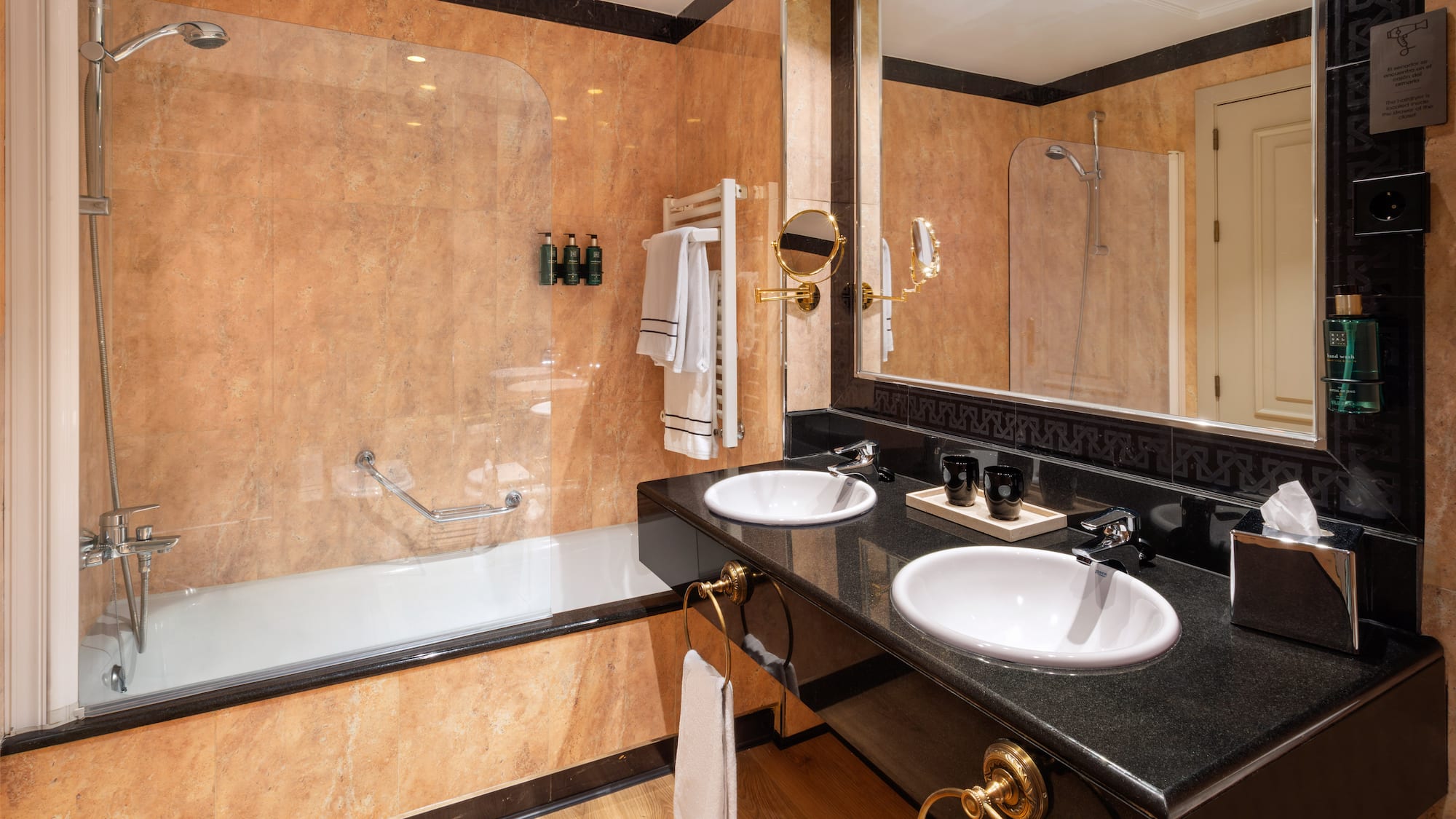 a bathroom with a large shower and two sinks