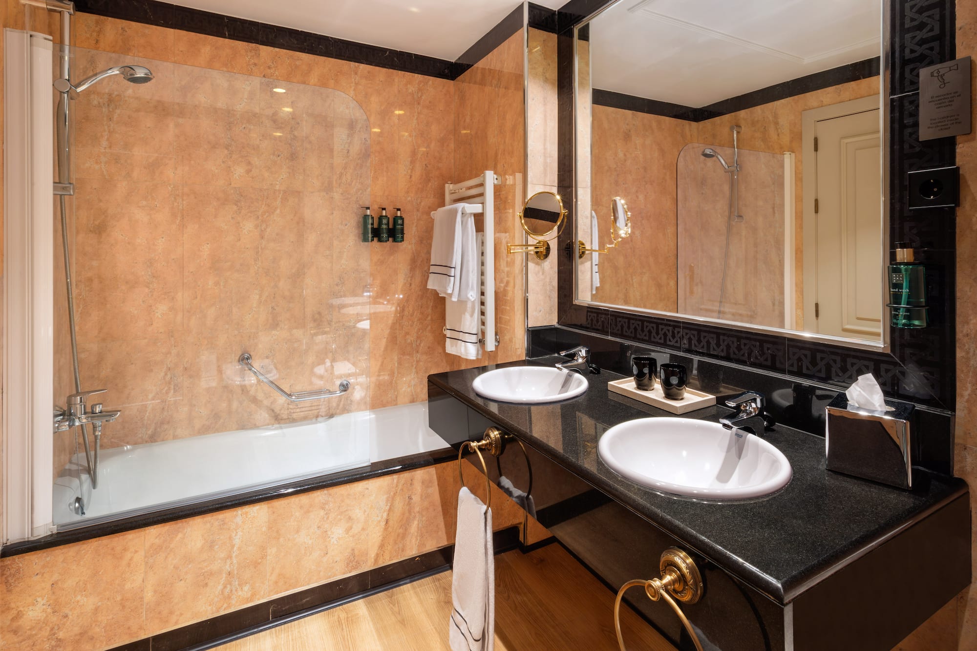 a bathroom with a large shower and two sinks