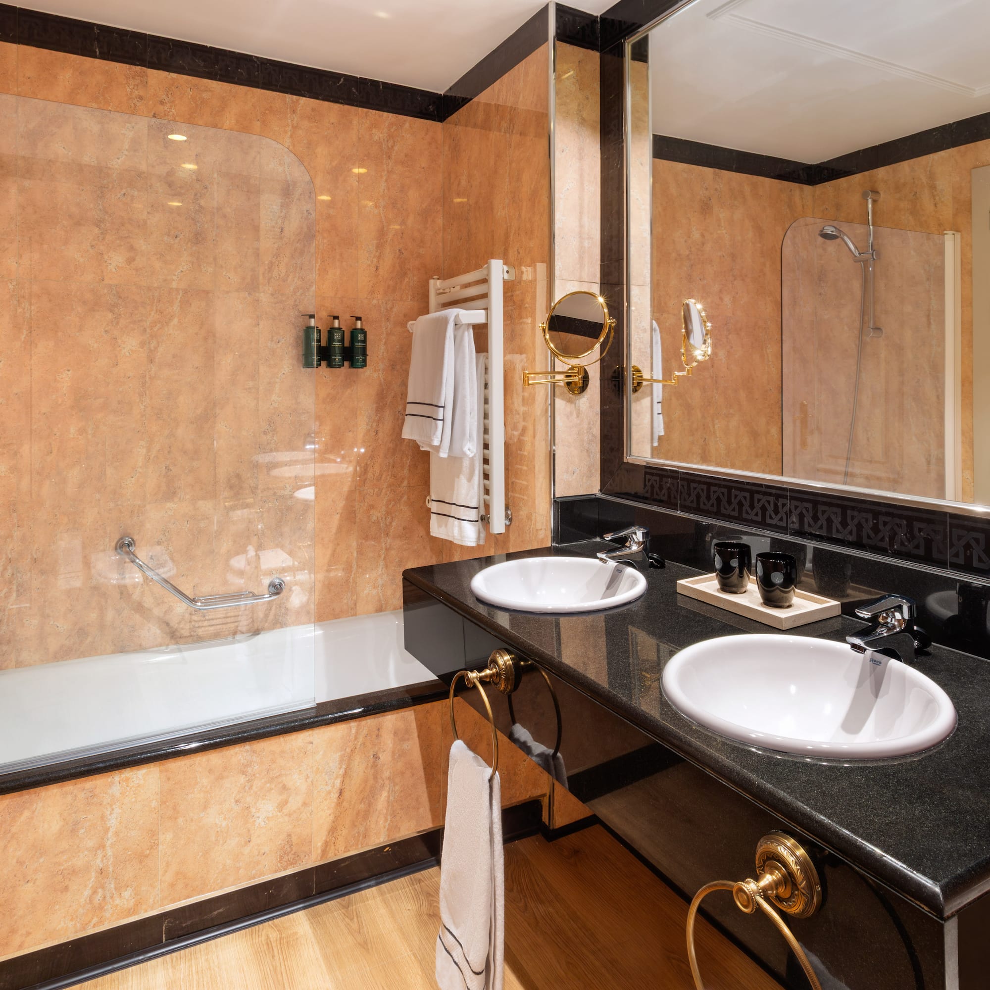 a bathroom with a large shower and two sinks