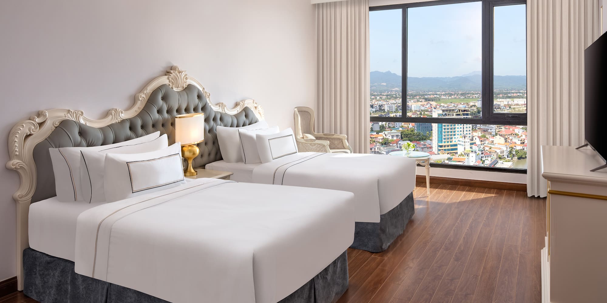 a room with two beds and a window