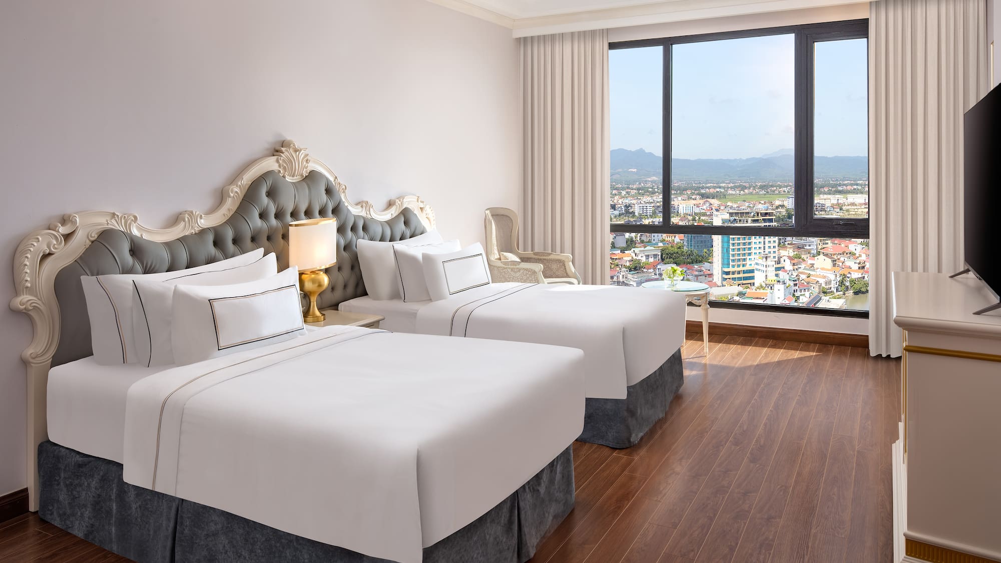 a room with two beds and a window