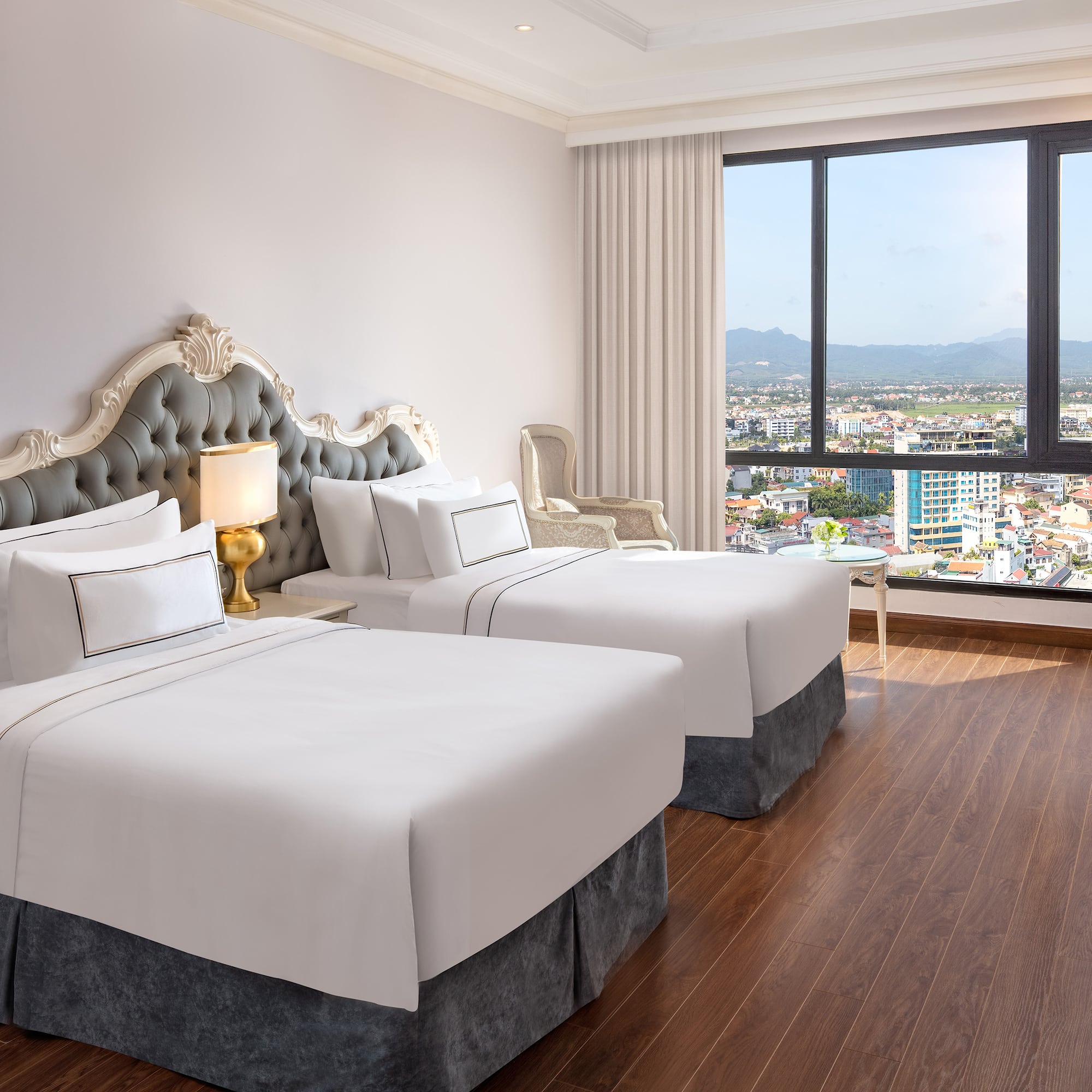 a room with two beds and a window