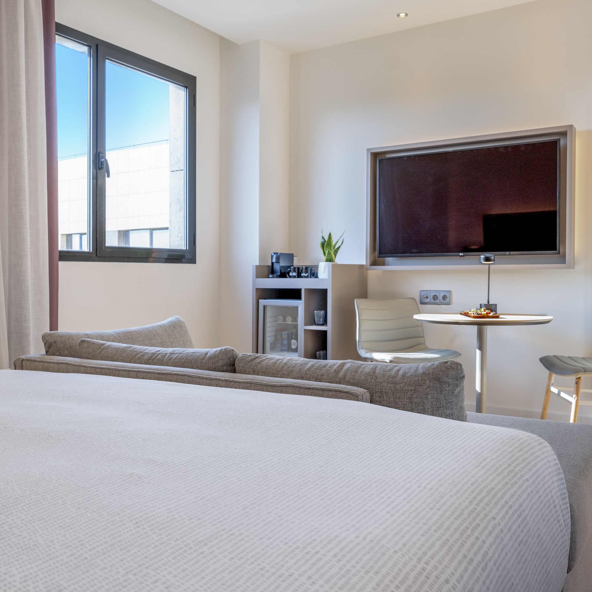 a room with a bed and a tv