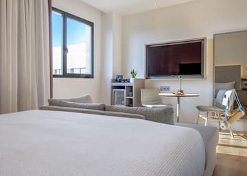 a room with a bed and a tv