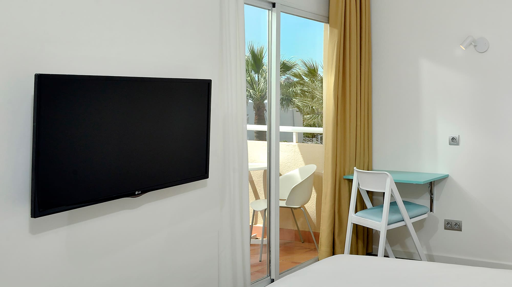 a room with a television on the wall