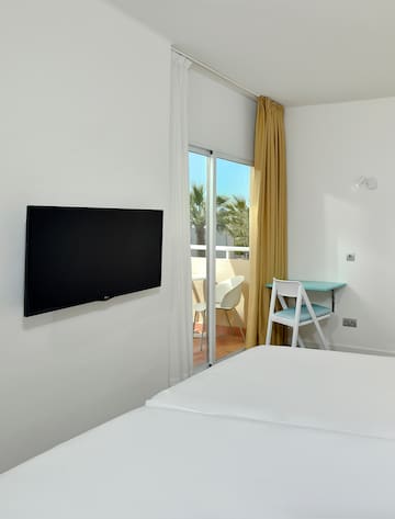 a room with a television on the wall