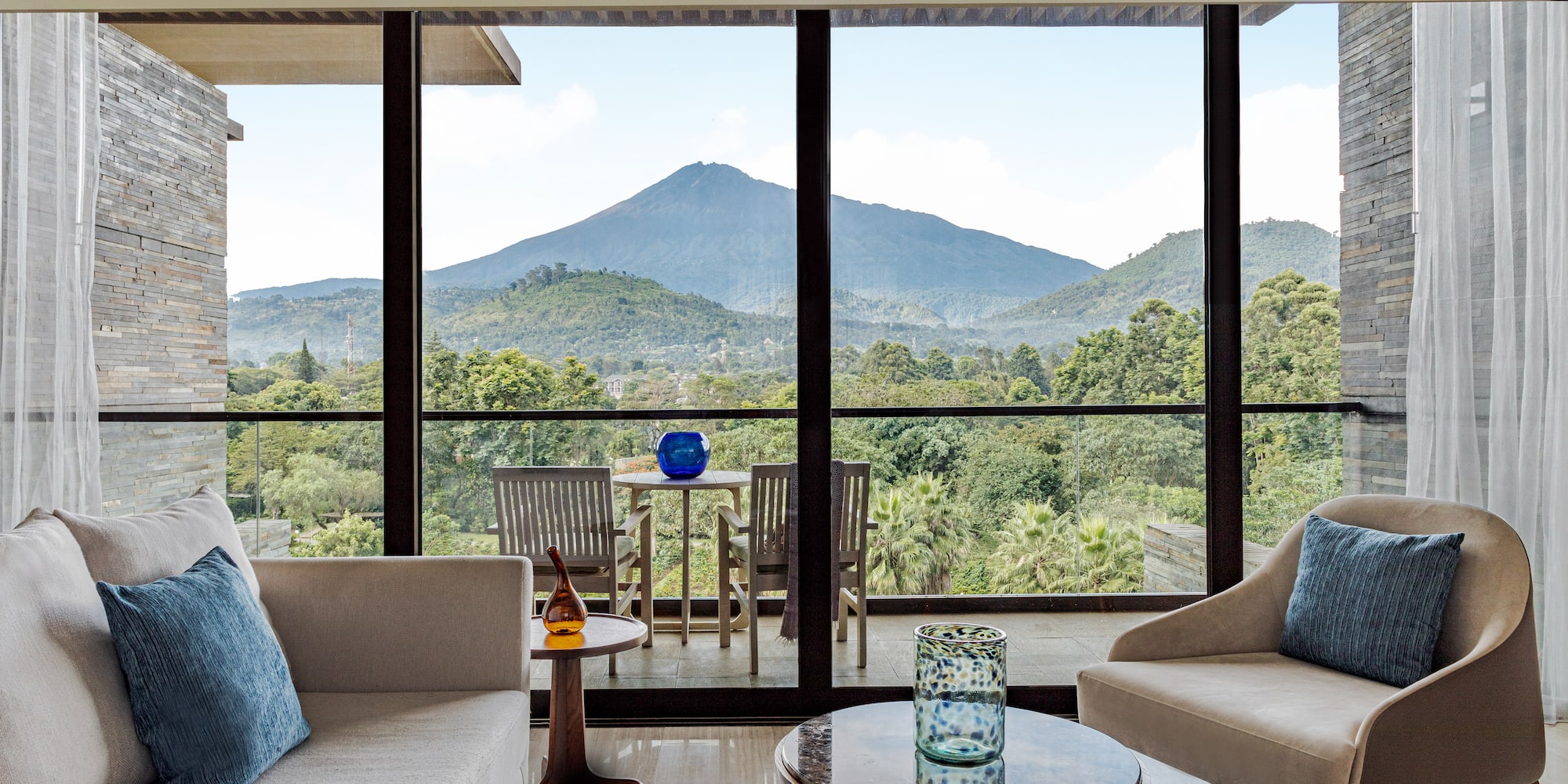 a living room with a view of mountains and trees