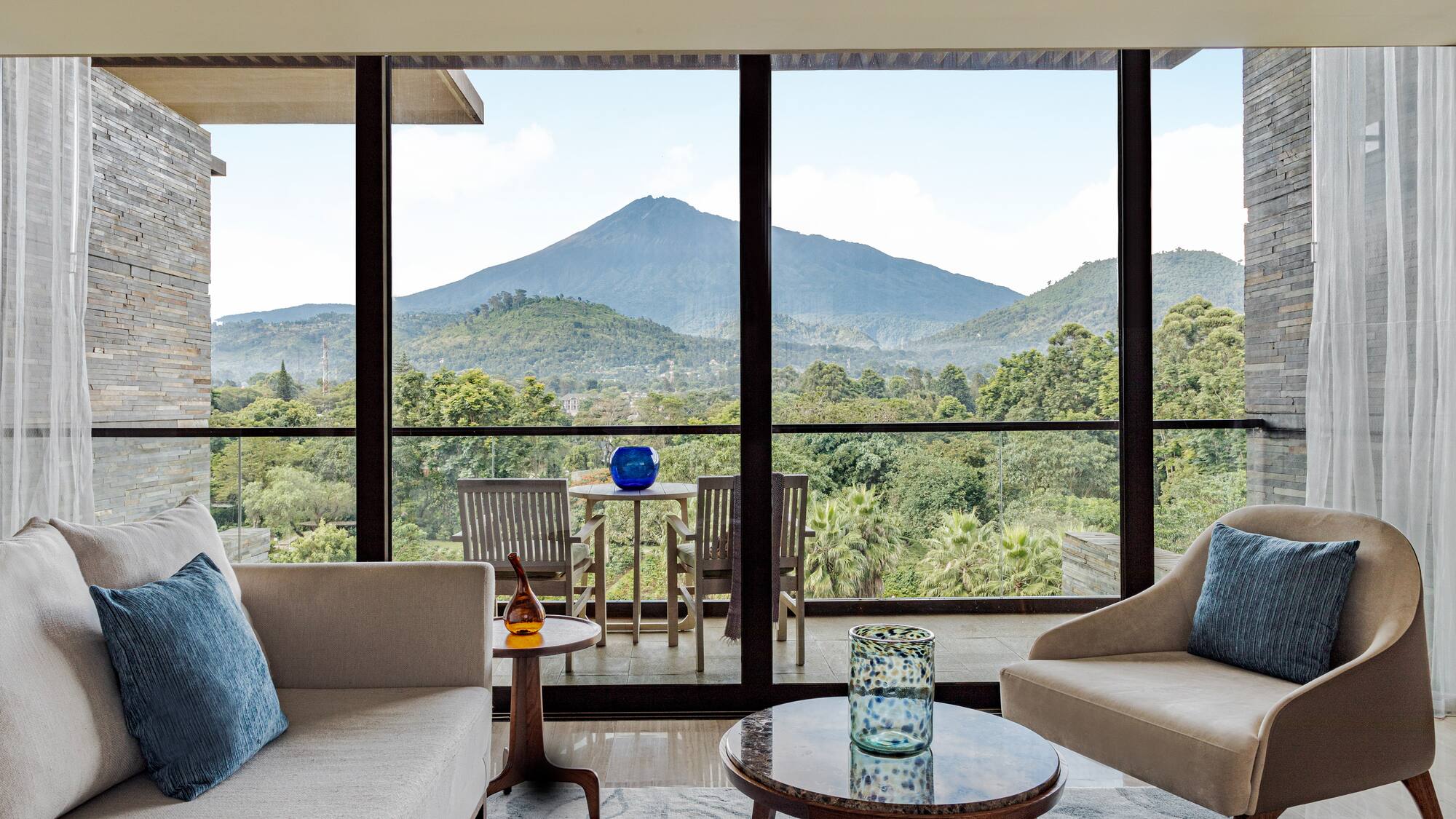 a living room with a view of mountains and trees