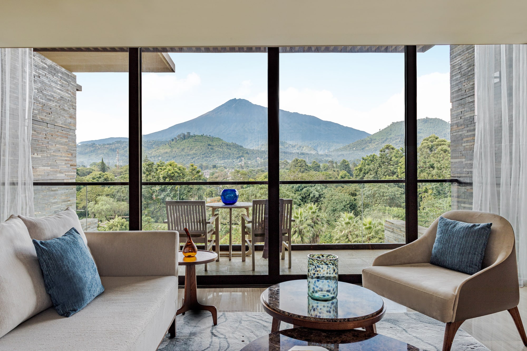 a living room with a view of mountains and trees