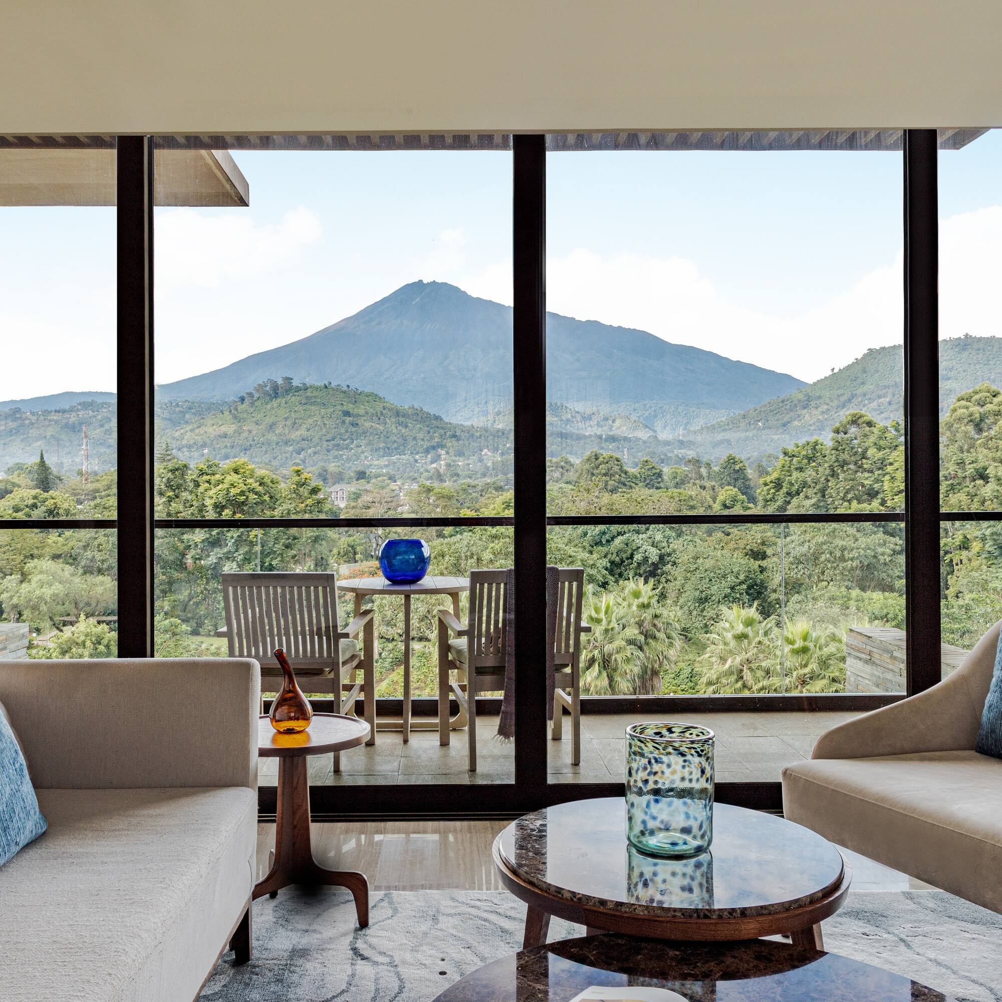 a living room with a view of mountains and trees