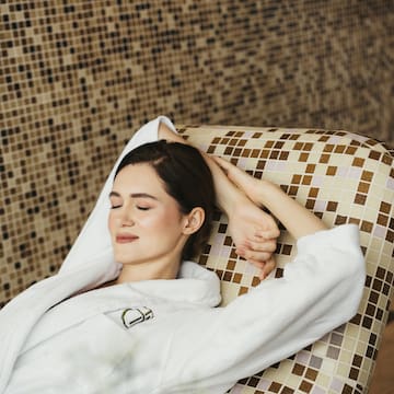 a woman lying on a chair with her eyes closed