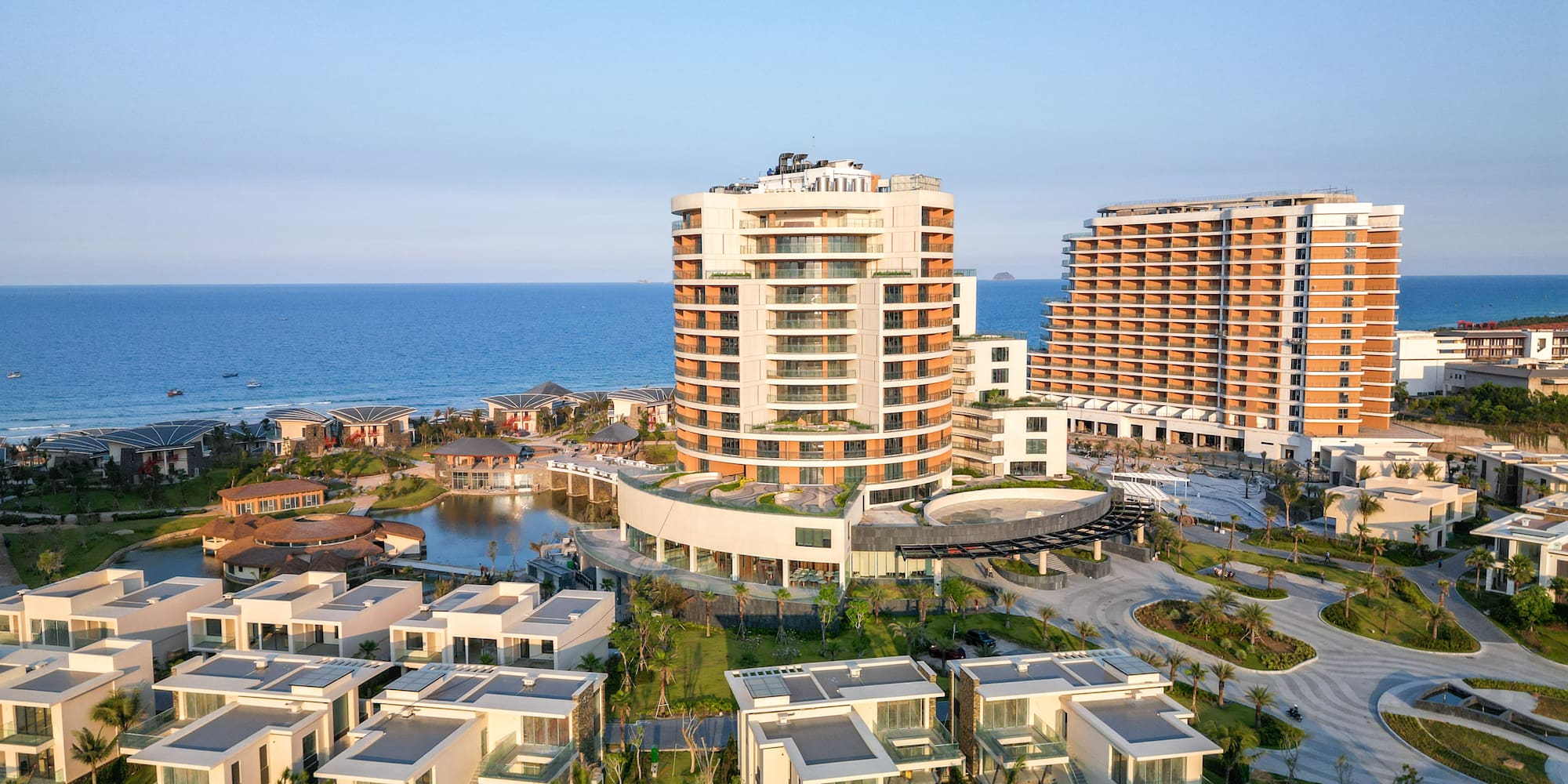 Luxury beachfront resort with modern hotels, villas, and ocean view.