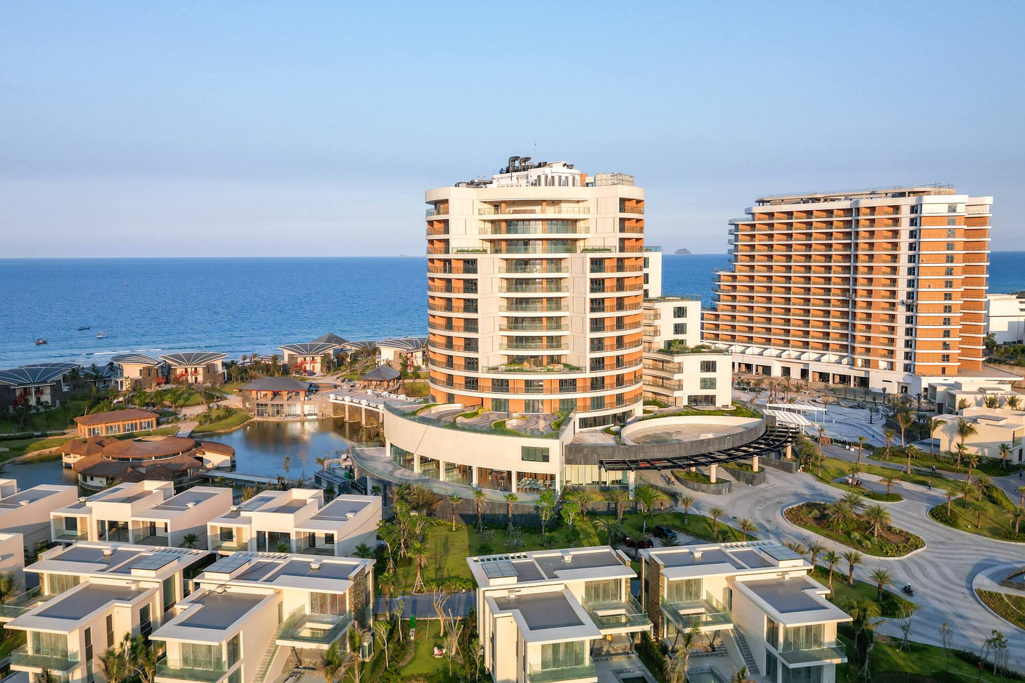 Luxury beachfront resort with modern hotels, villas, and ocean view.