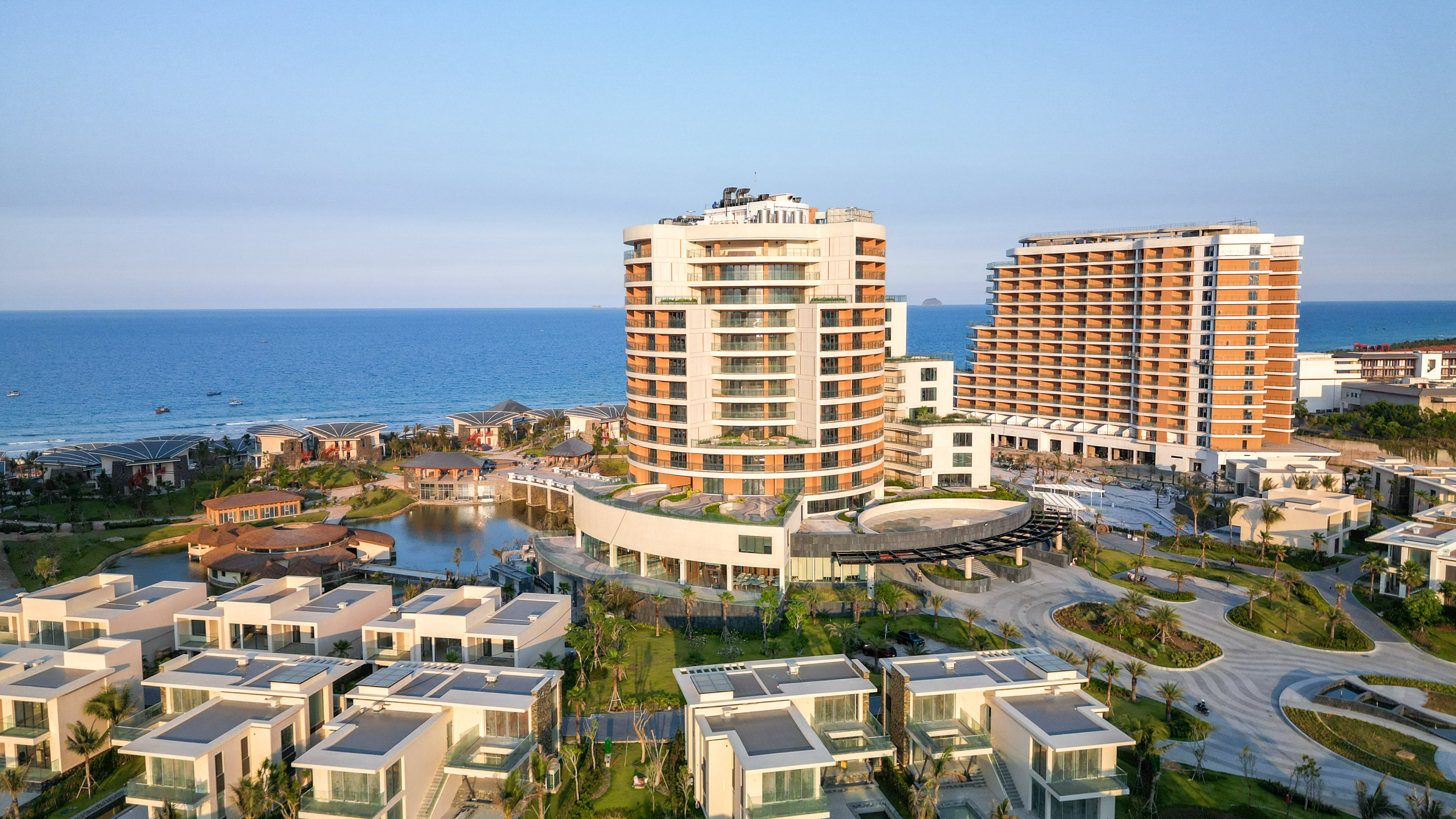 Luxury beachfront resort with modern hotels, villas, and ocean view.
