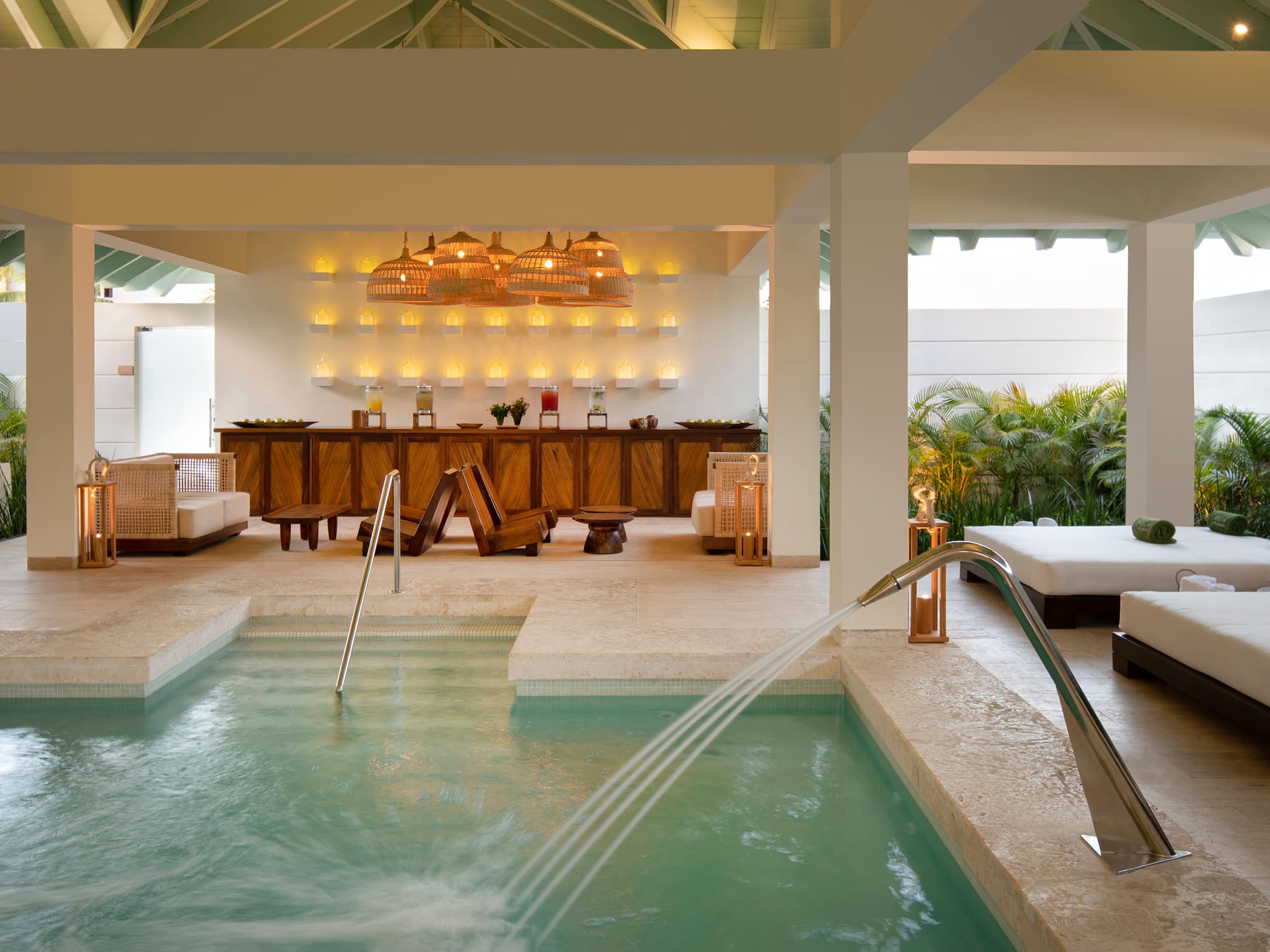 a pool with a waterfall in the middle of a room