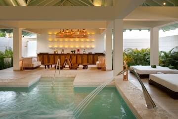 a pool with a waterfall in the middle of a room