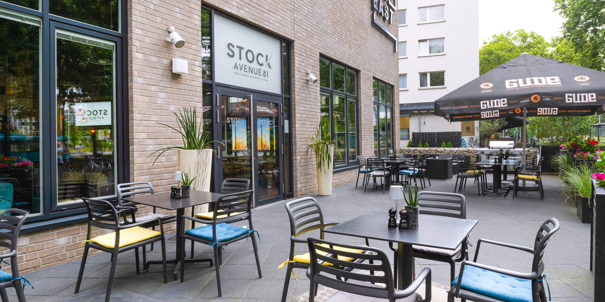 a restaurant with tables and chairs outside